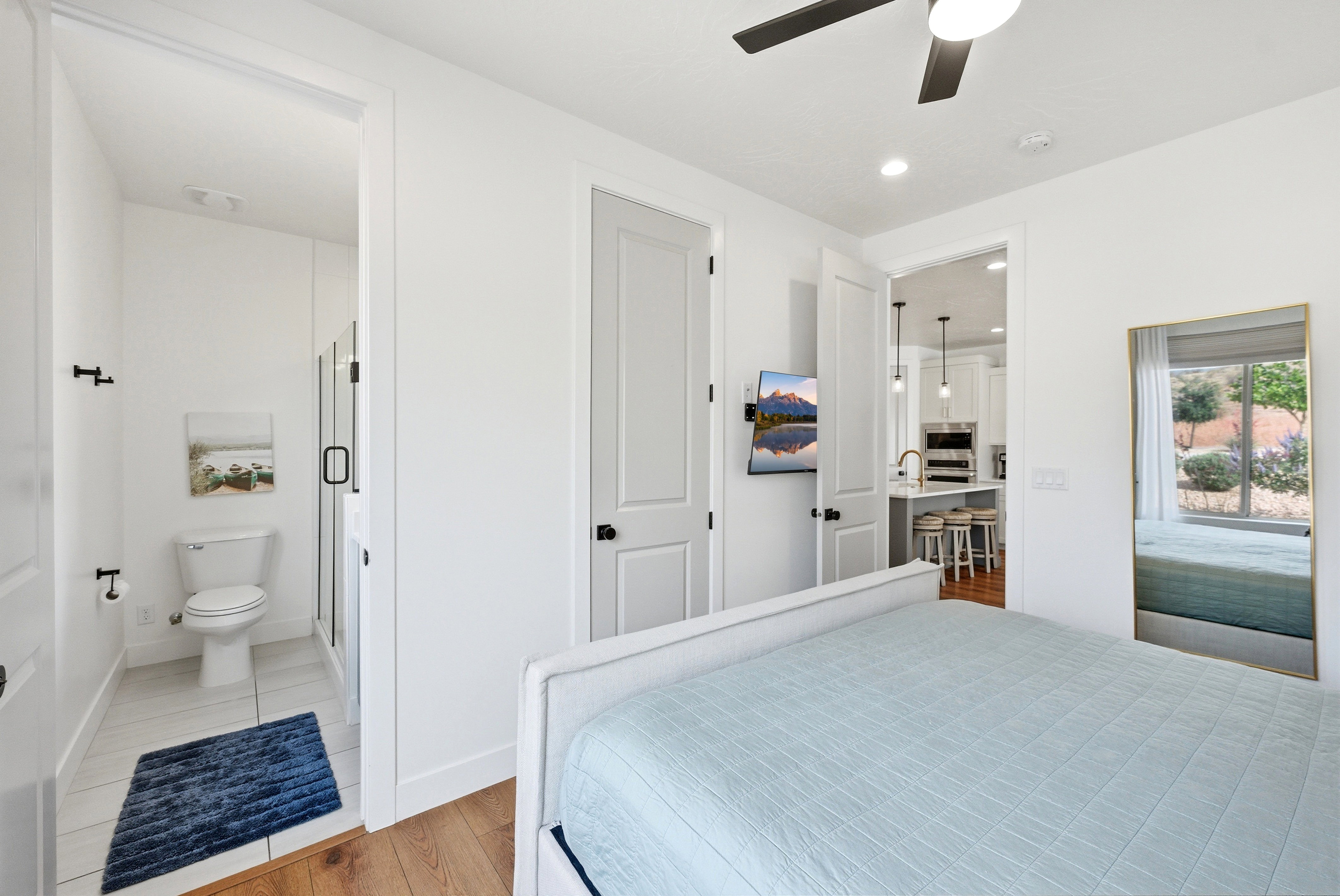 White-painted interior featuring wood-finish flooring, a ceiling fan, and recessed lighting