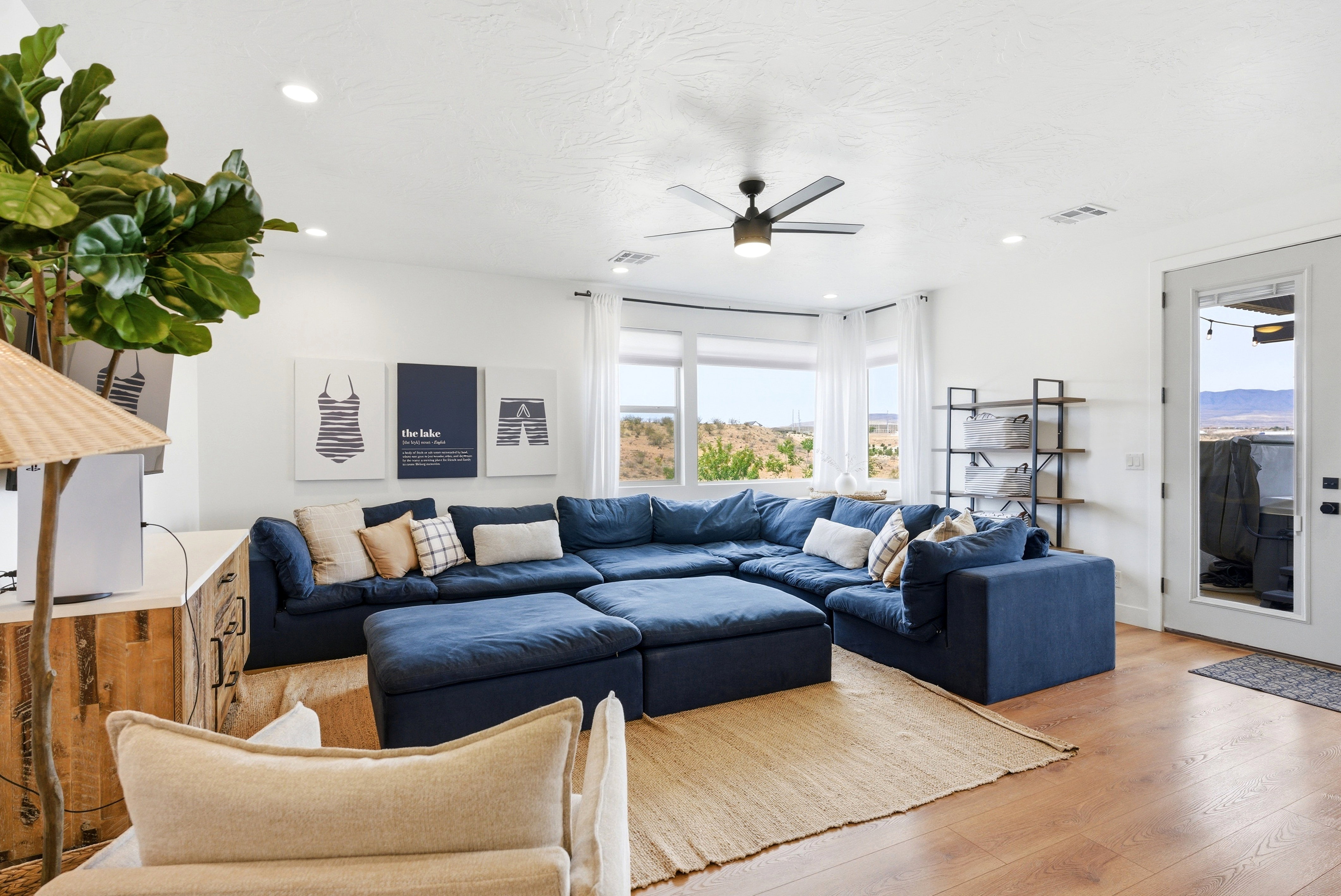 Spacious living area featuring wood-finish flooring, recessed lighting, and a ceiling fan