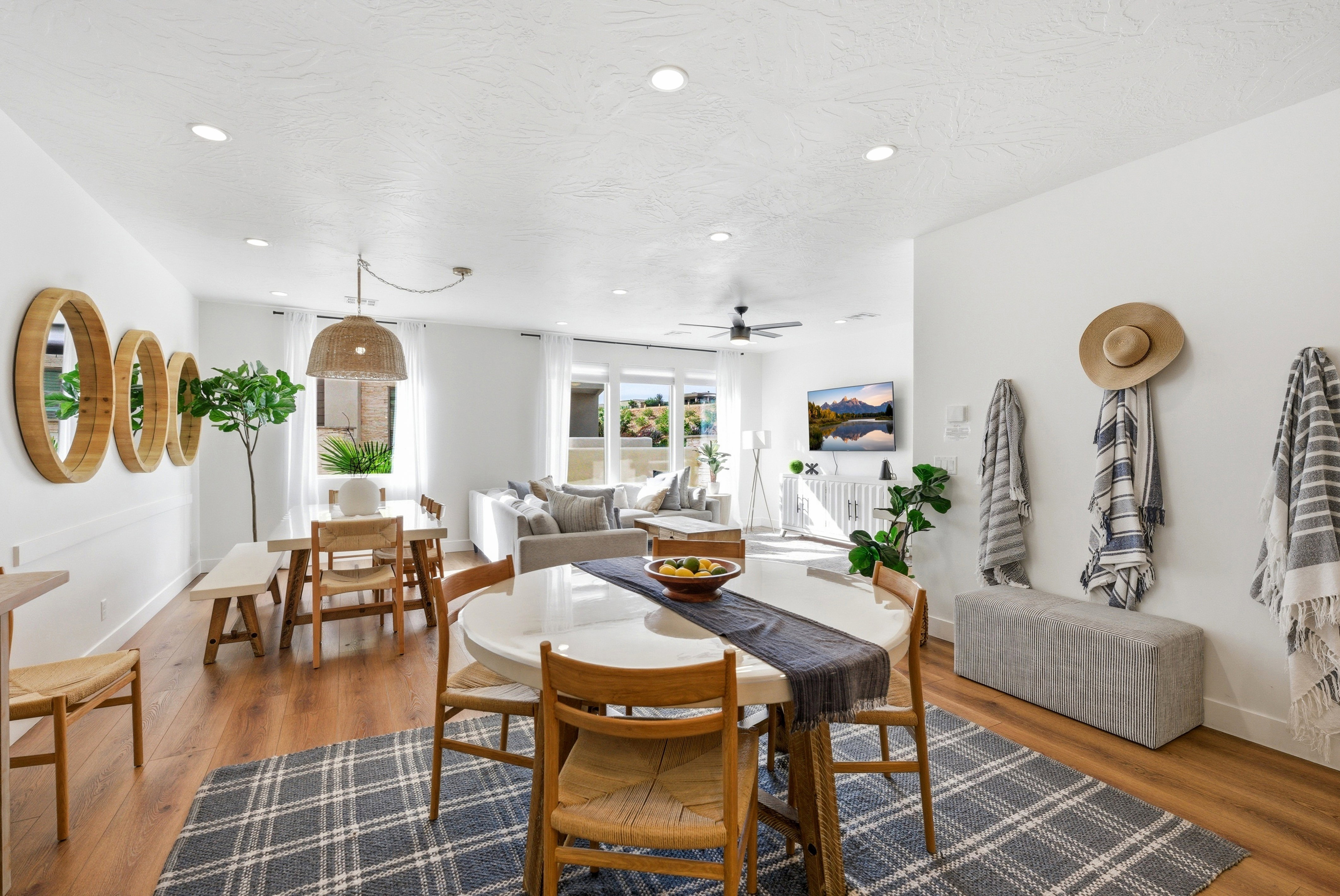 Open-concept interior featuring wood-finish flooring, recessed lighting, and a neutral color palette