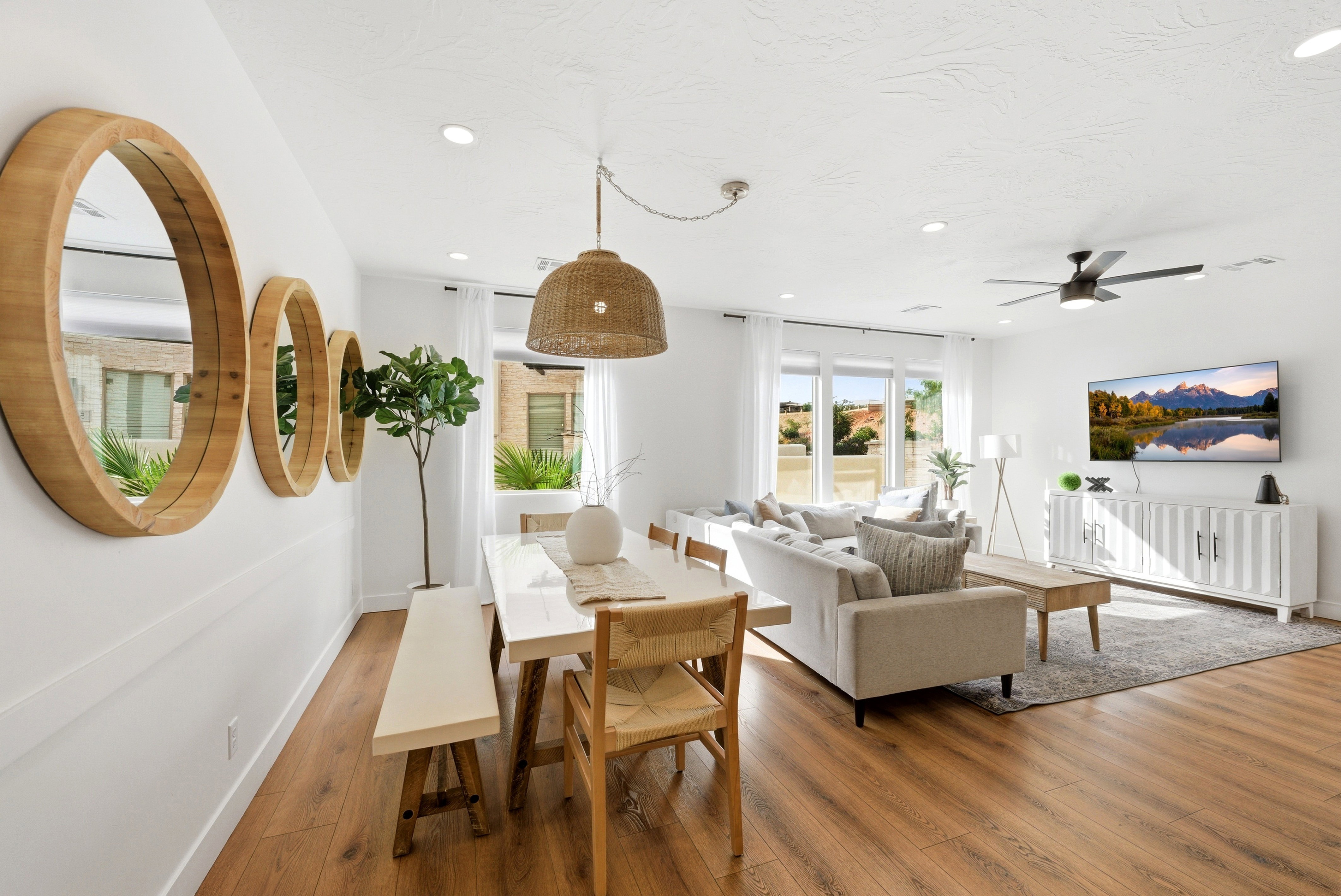 Open-concept living area featuring wood-finish flooring, recessed lighting, and a contemporary ceiling fan
