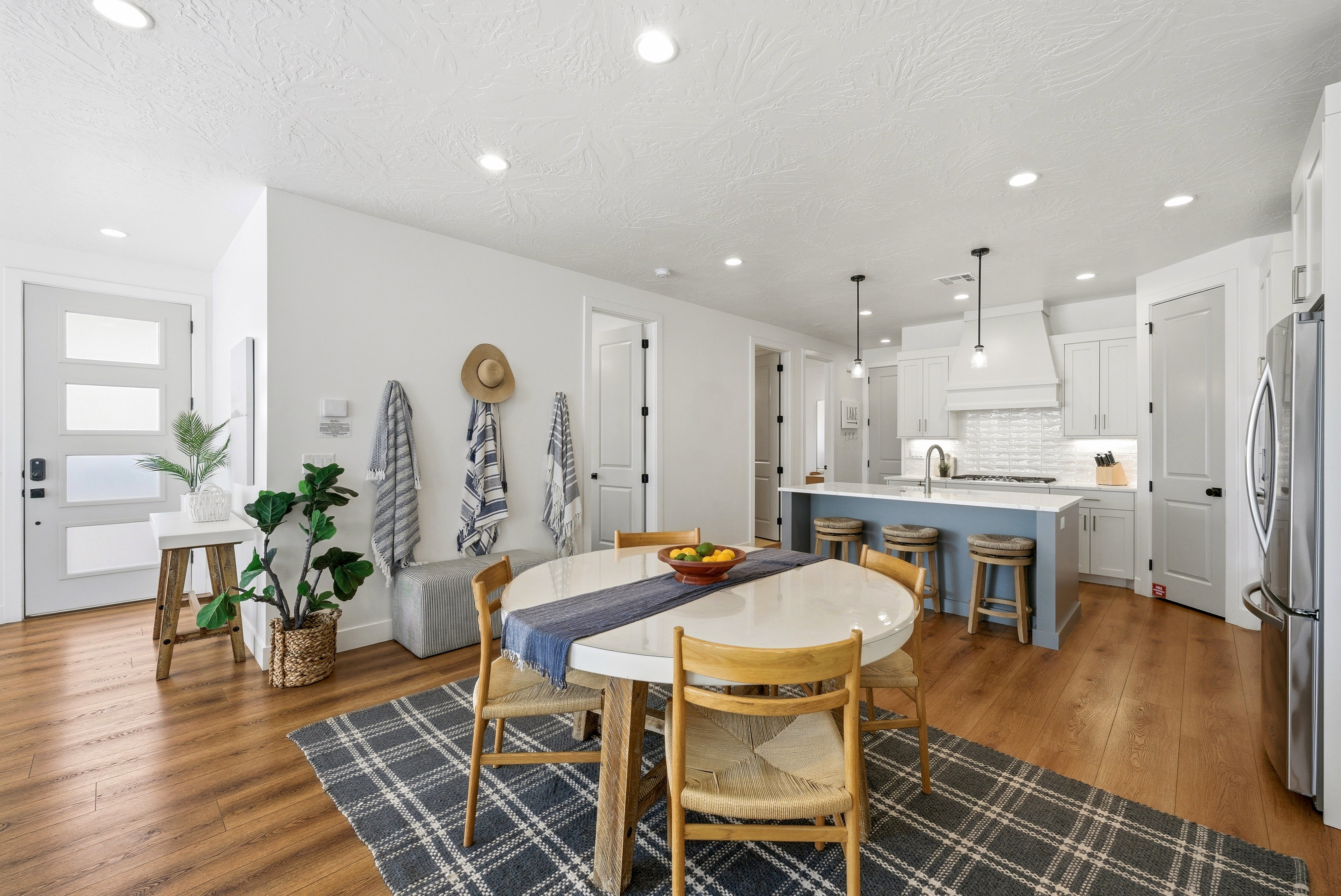 Open-concept living space featuring wood-finish flooring and recessed lighting