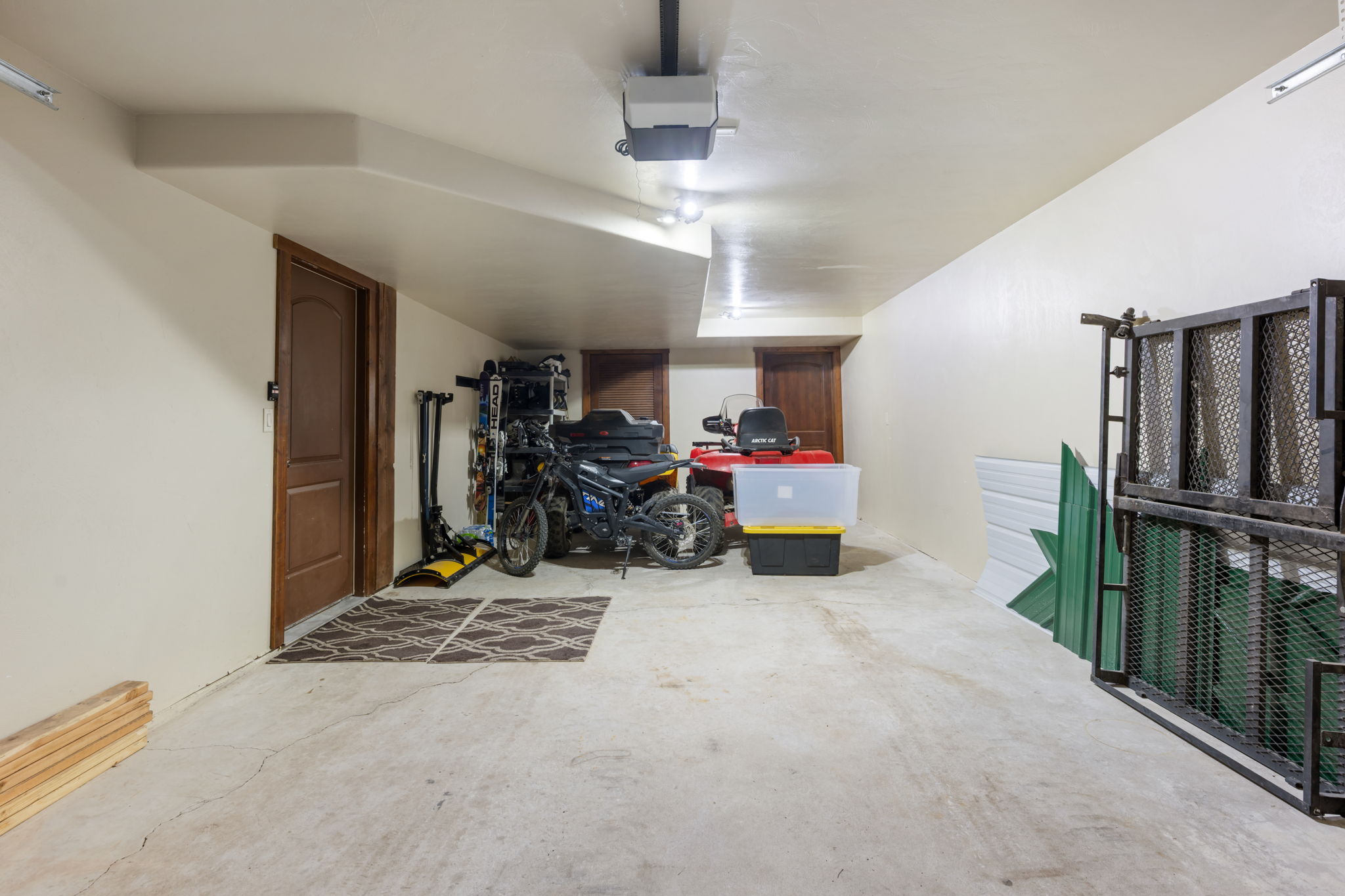 Expansive garage featuring a concrete floor, recessed lighting, and a projector system