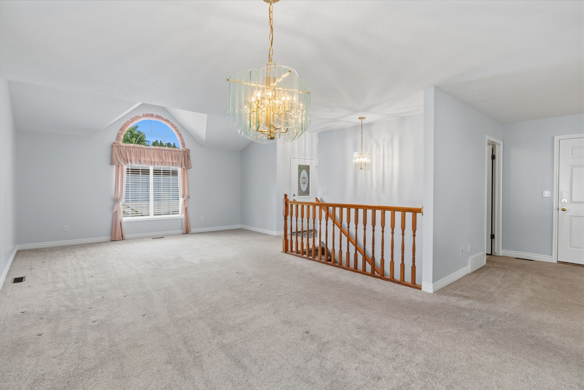 Spacious interior with neutral carpeting and light-toned walls