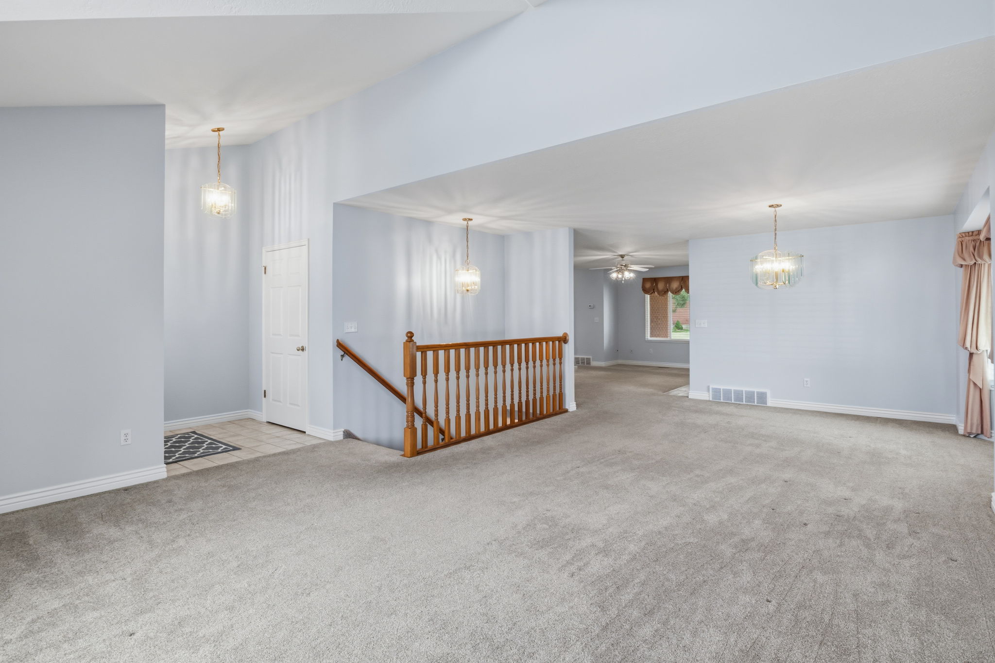 Spacious interior featuring vaulted ceilings and neutral wall tones