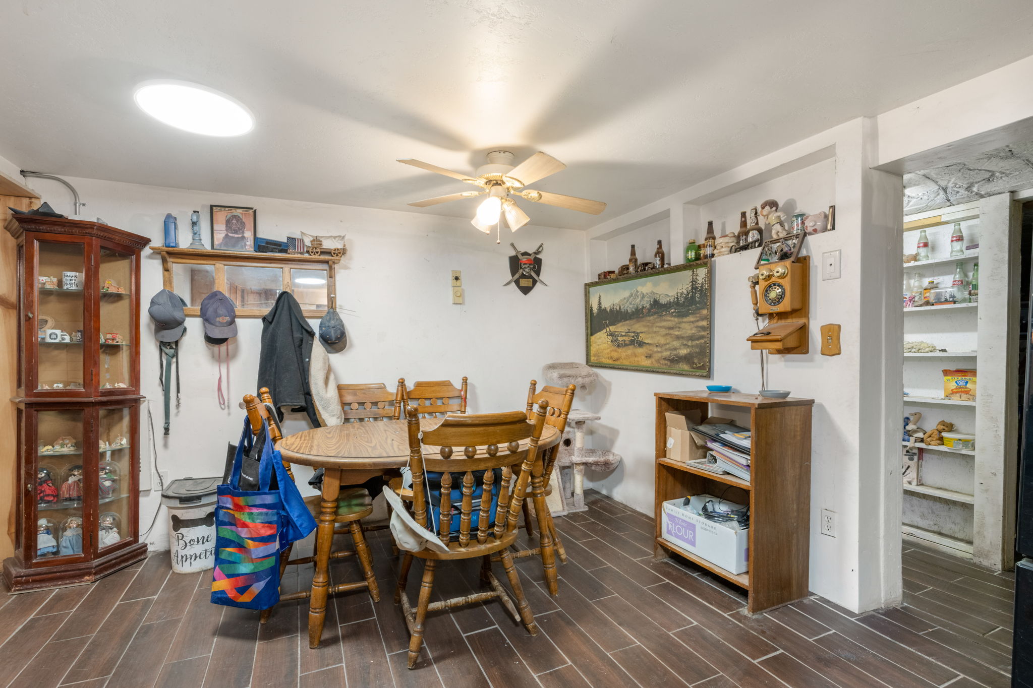 Dining area featuring wood-finish flooring and a ceiling fan with integrated lighting