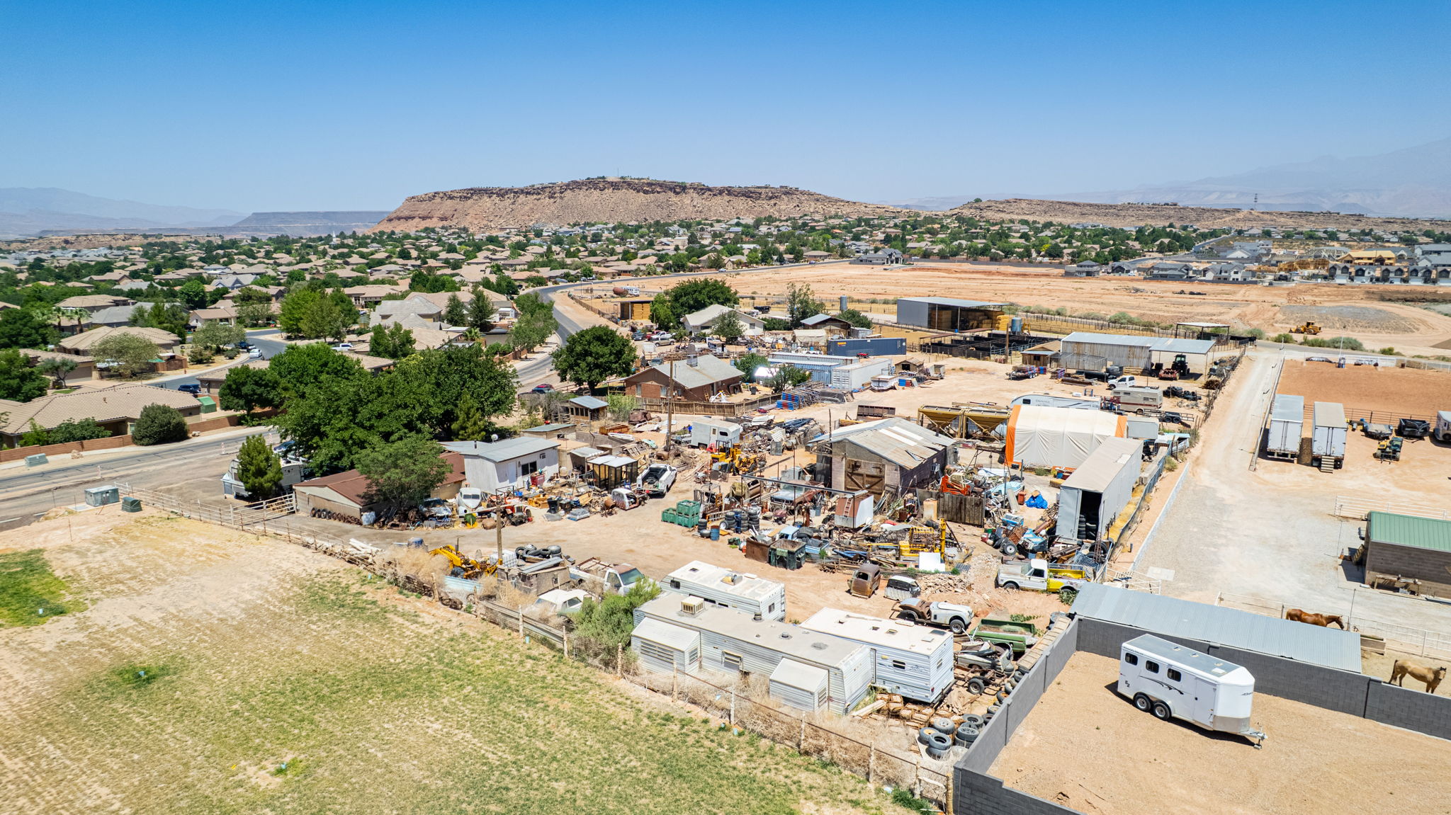 Expansive land parcel with multiple structures, including several sheds and a large open area