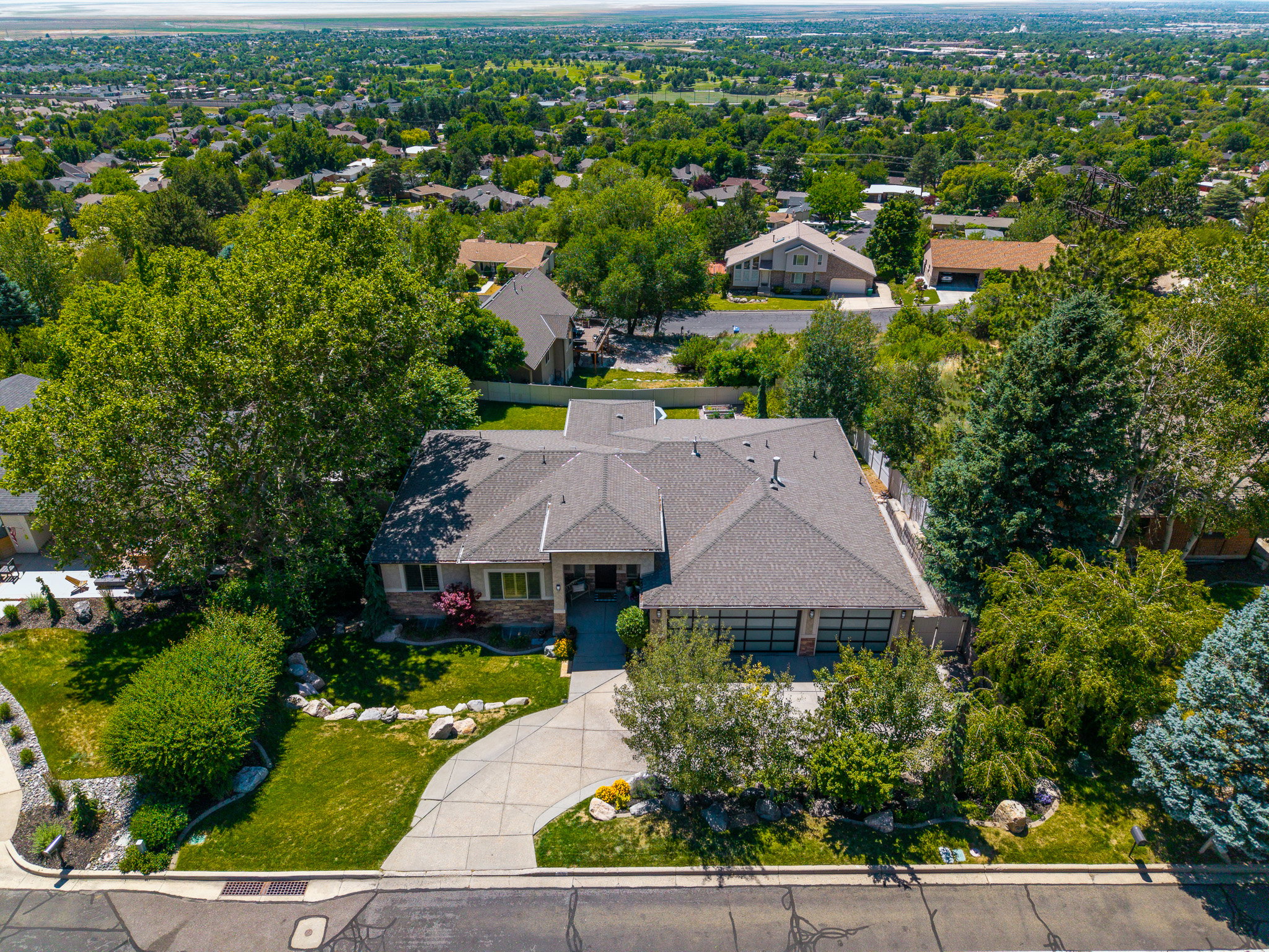 Single-story residence featuring a multi-gabled roofline and an attached two-car garage with frosted glass panels