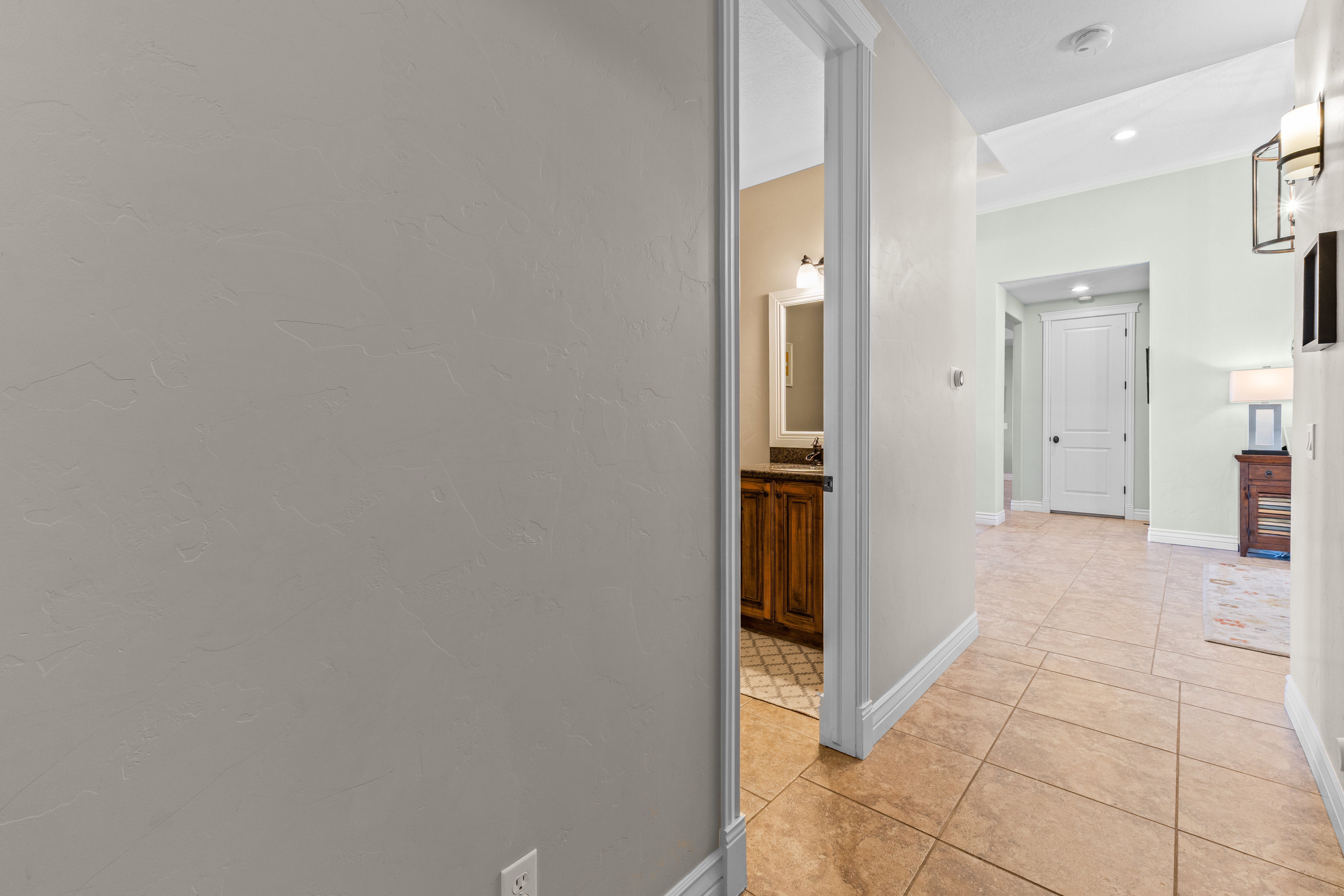 Hallway featuring tile flooring and crown molding