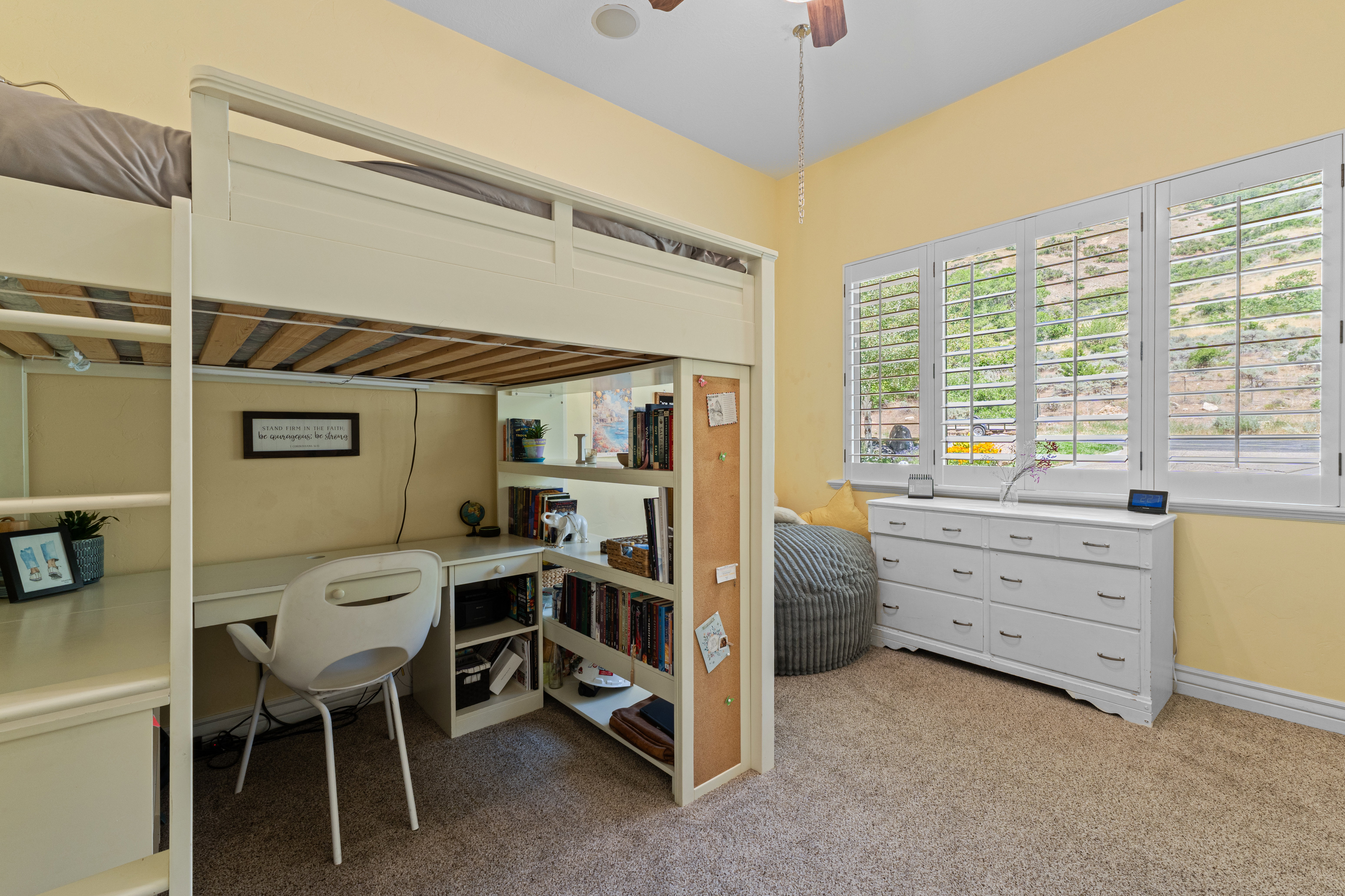 Integrated loft bed with a built-in desk and shelving