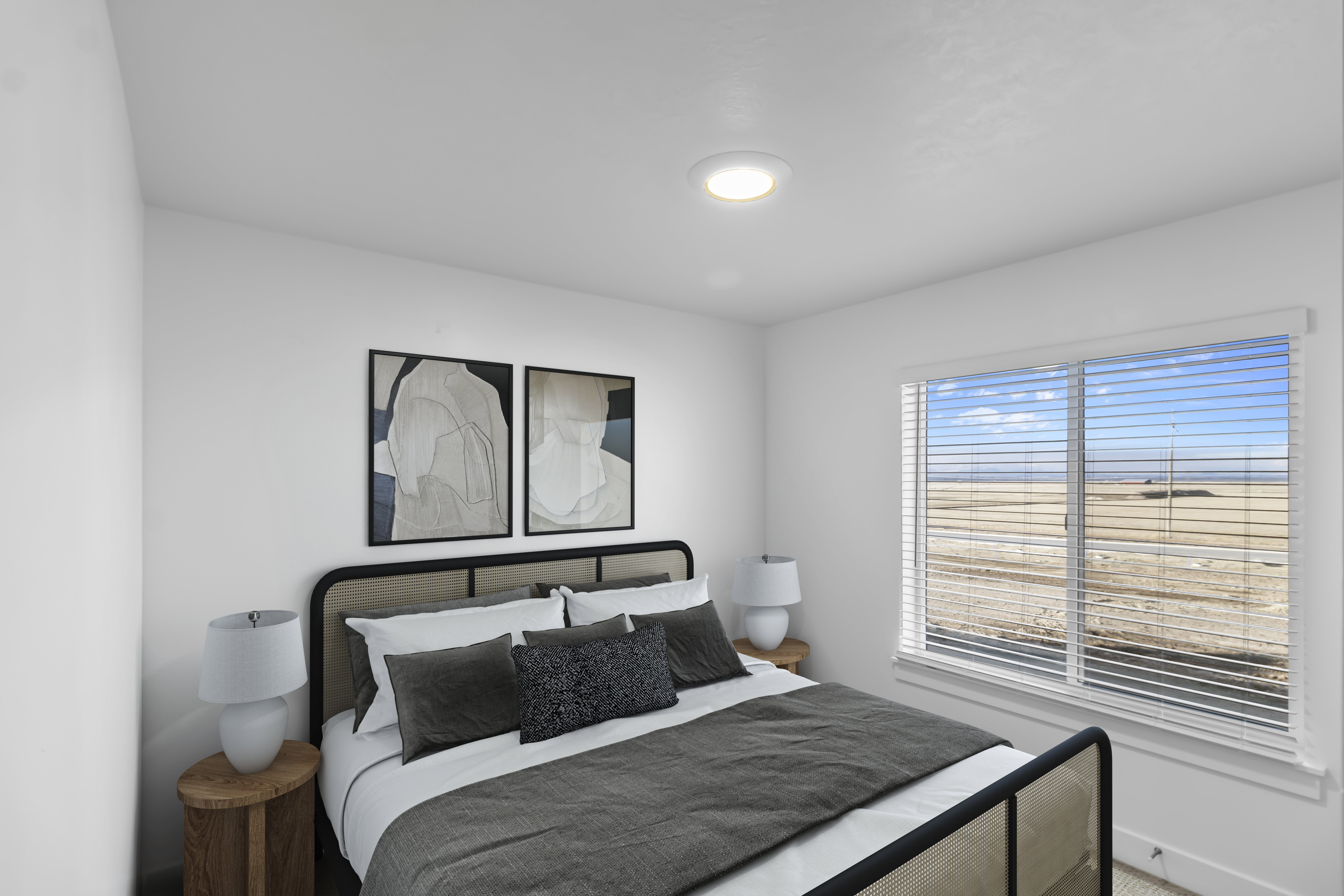 Bright bedroom featuring a large window with horizontal blinds, white walls, and a ceiling-mounted light fixture