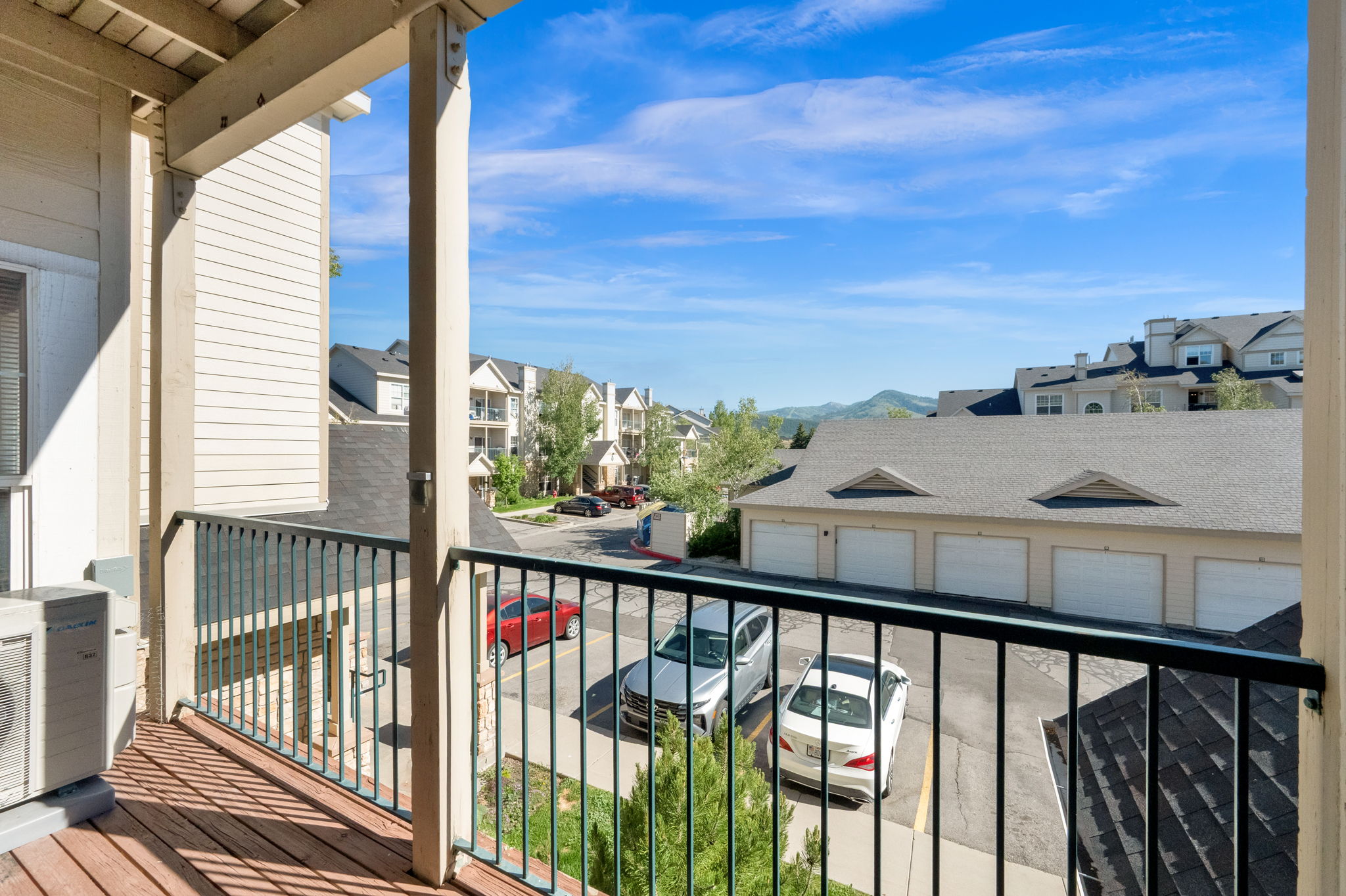 Balcony with wood-finish flooring and black metal railing