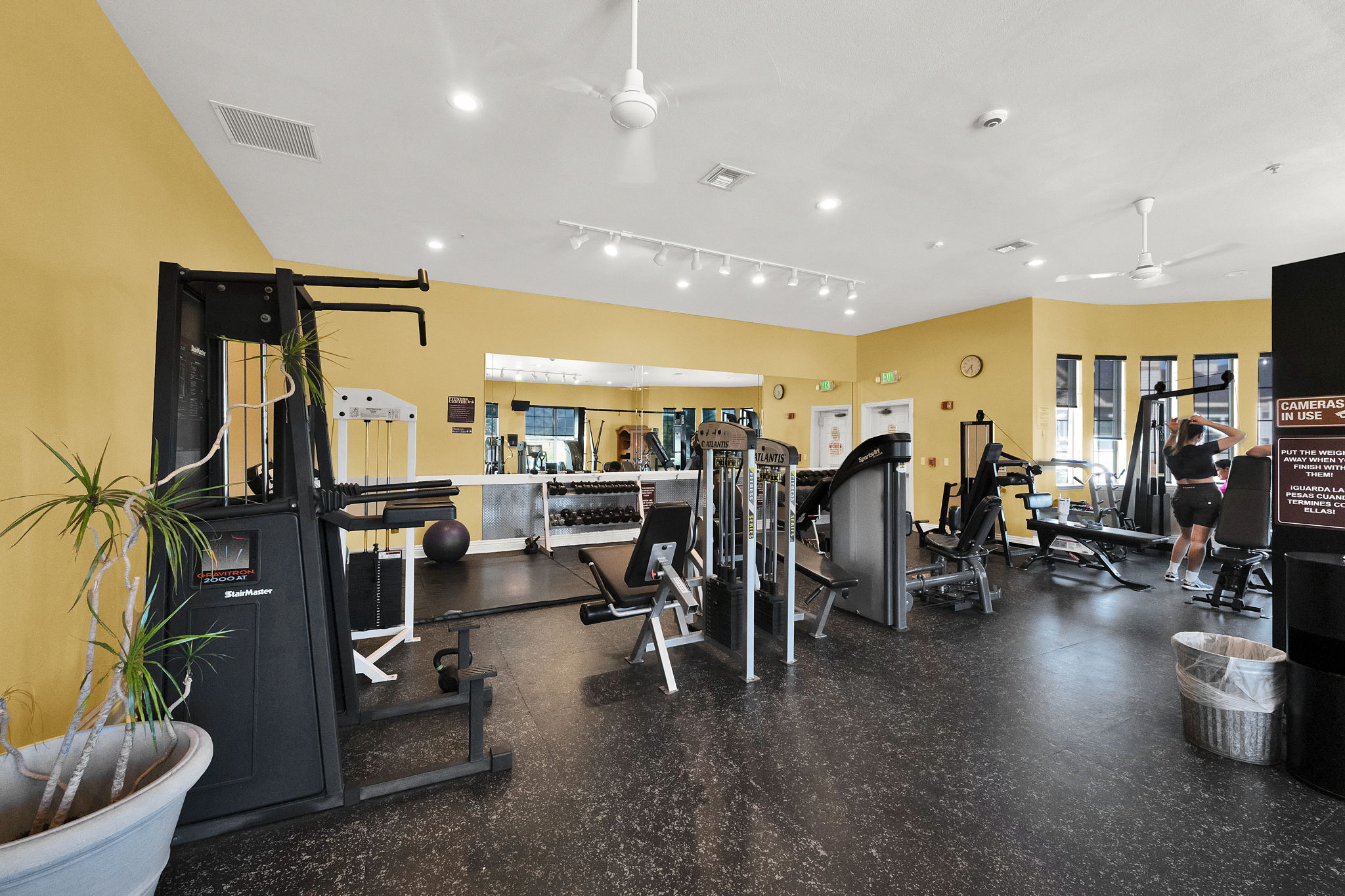 Fitness center featuring multiple exercise machines, weight equipment, rubberized flooring, and recessed lighting