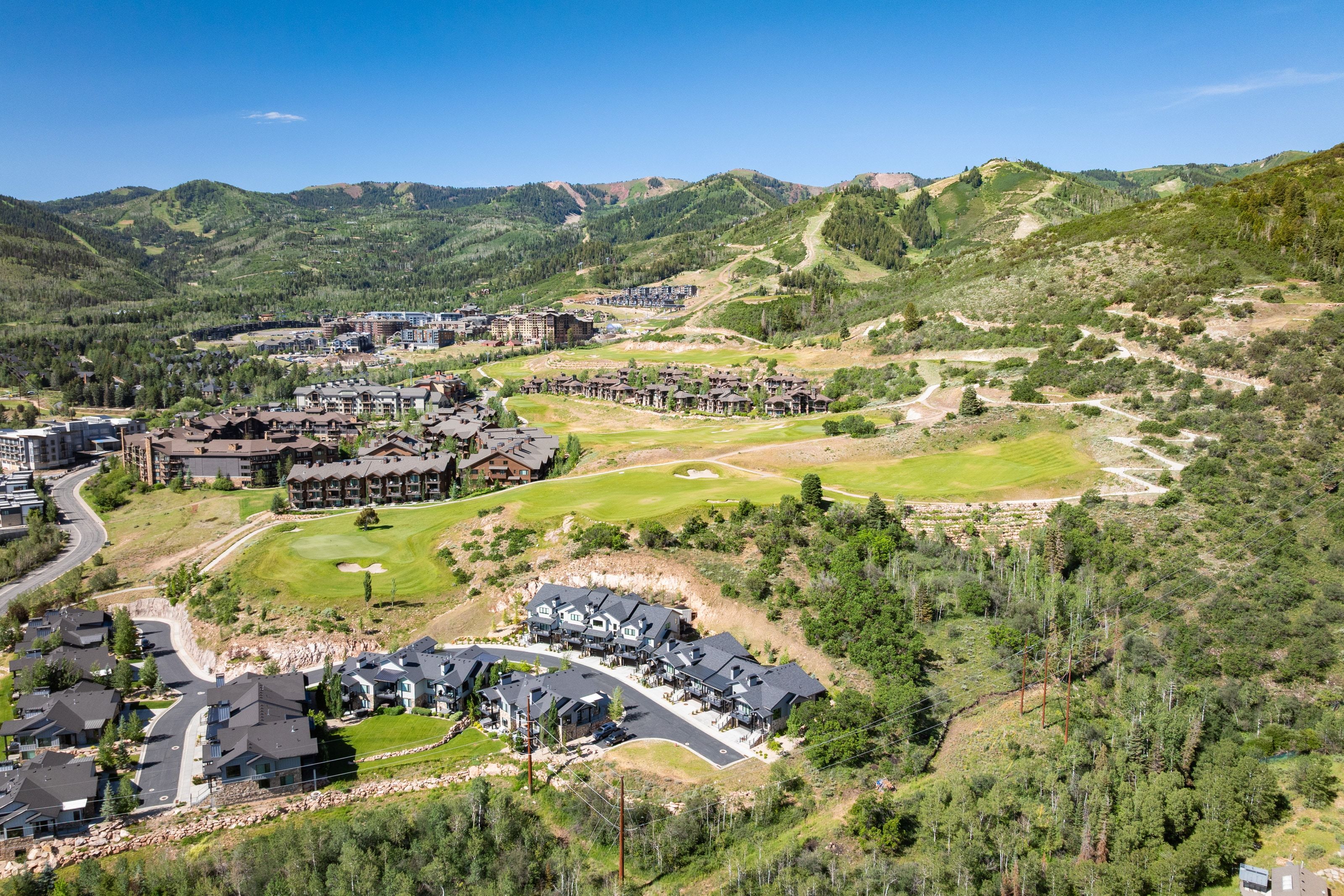 Aerial perspective showcasing a residential community nestled within a mountainous landscape