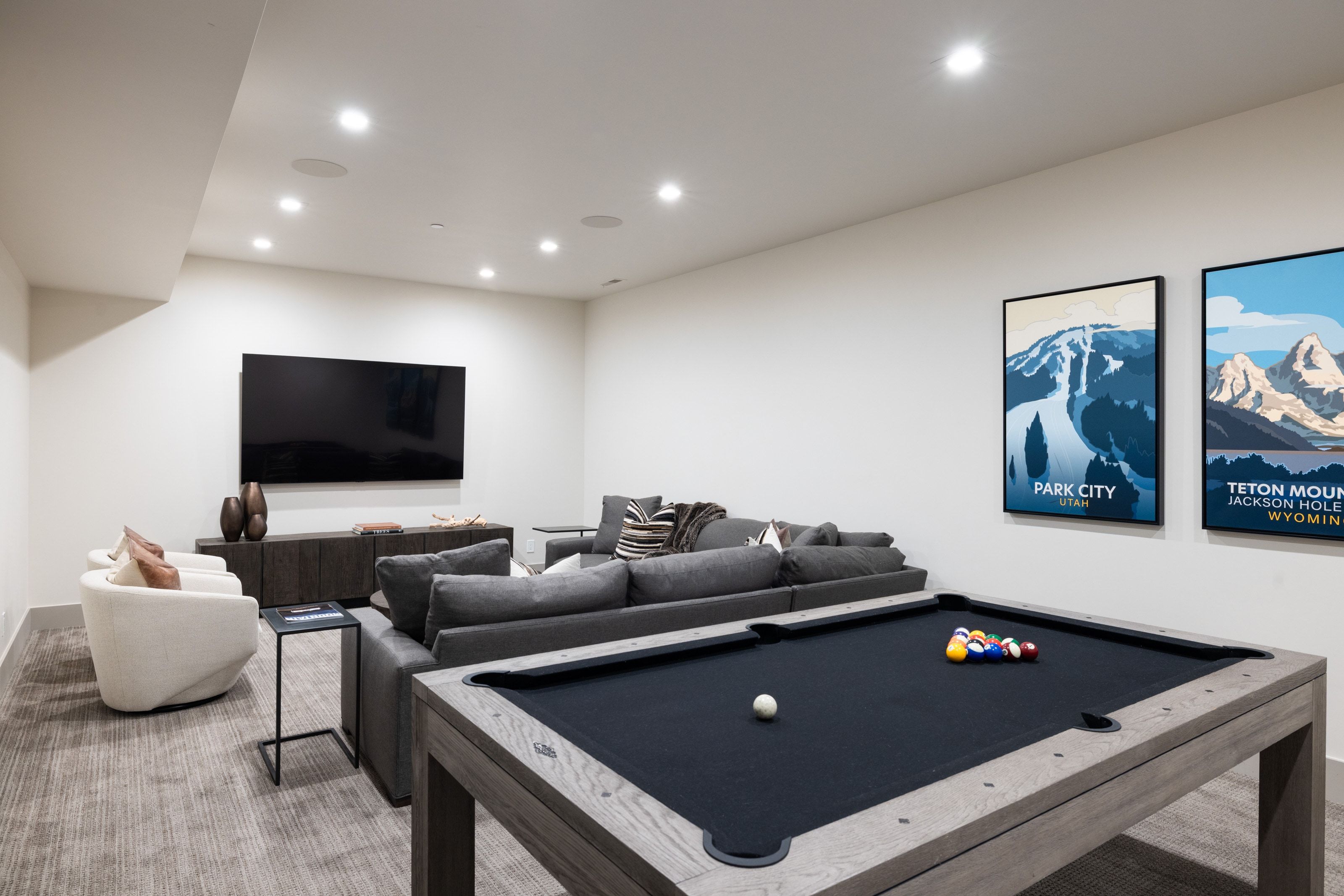 Spacious recreation area featuring recessed lighting and wall-mounted television
