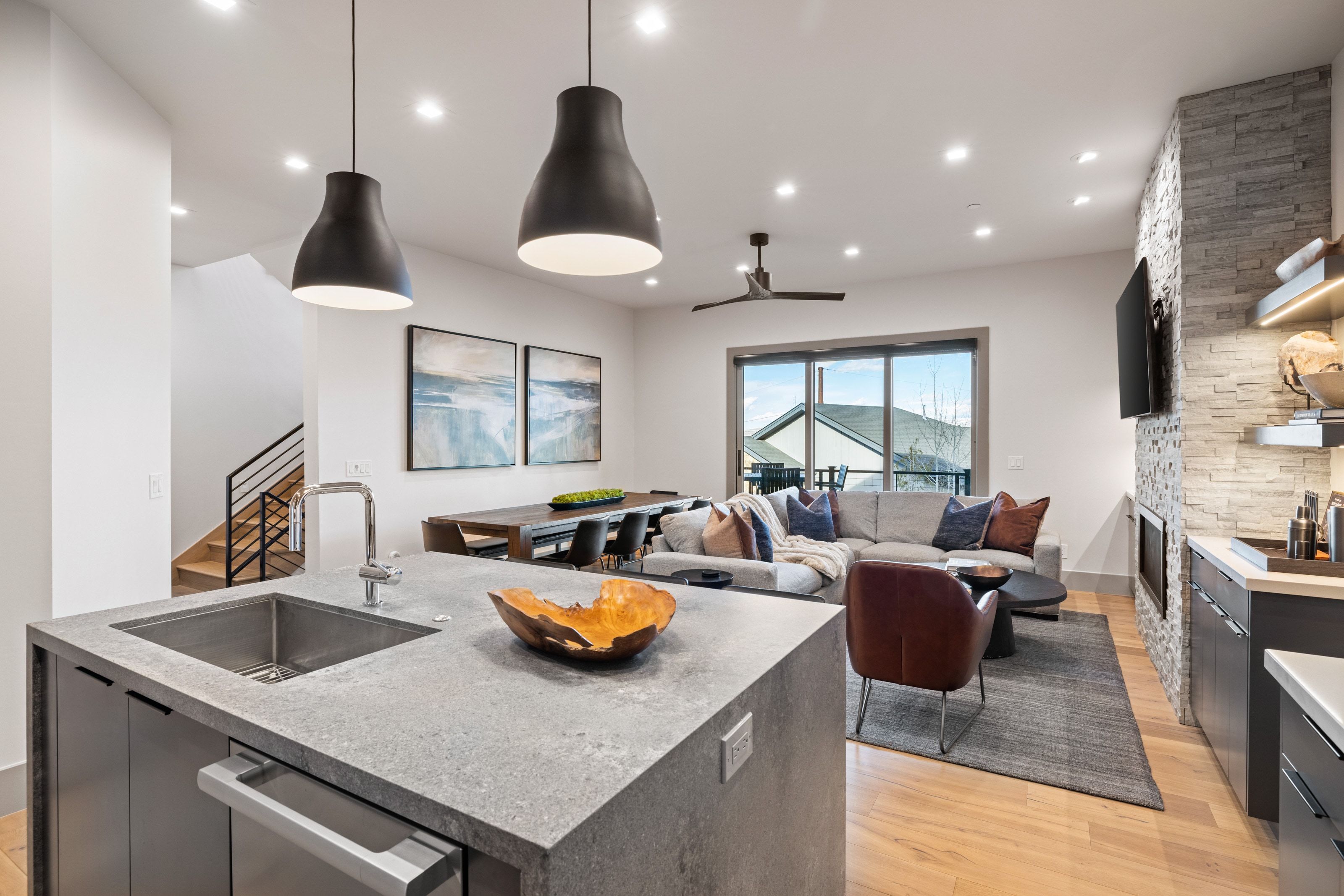 Open-concept living space featuring a substantial kitchen island with an undermount sink and integrated dishwasher