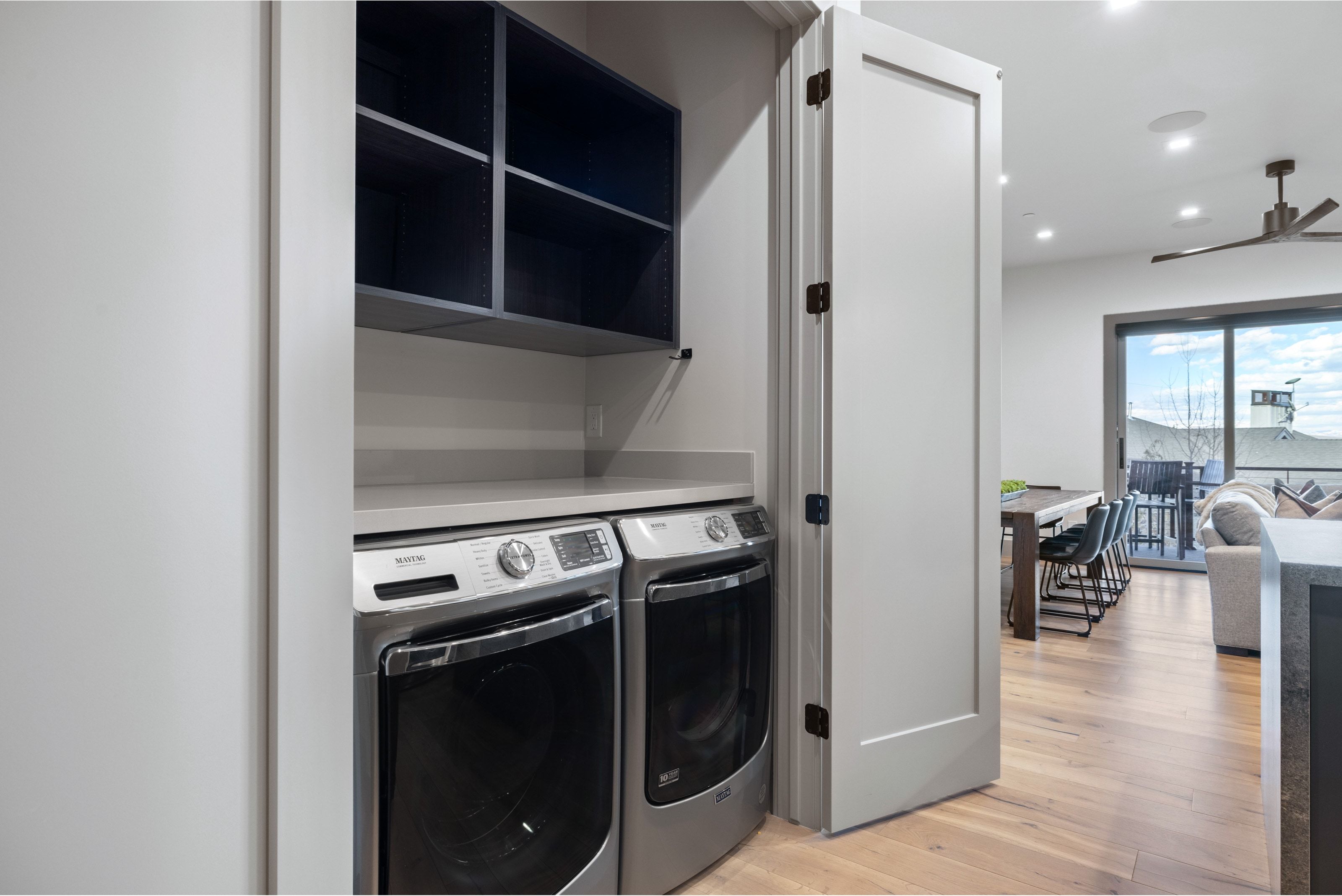 Dedicated laundry area featuring a countertop and integrated shelving