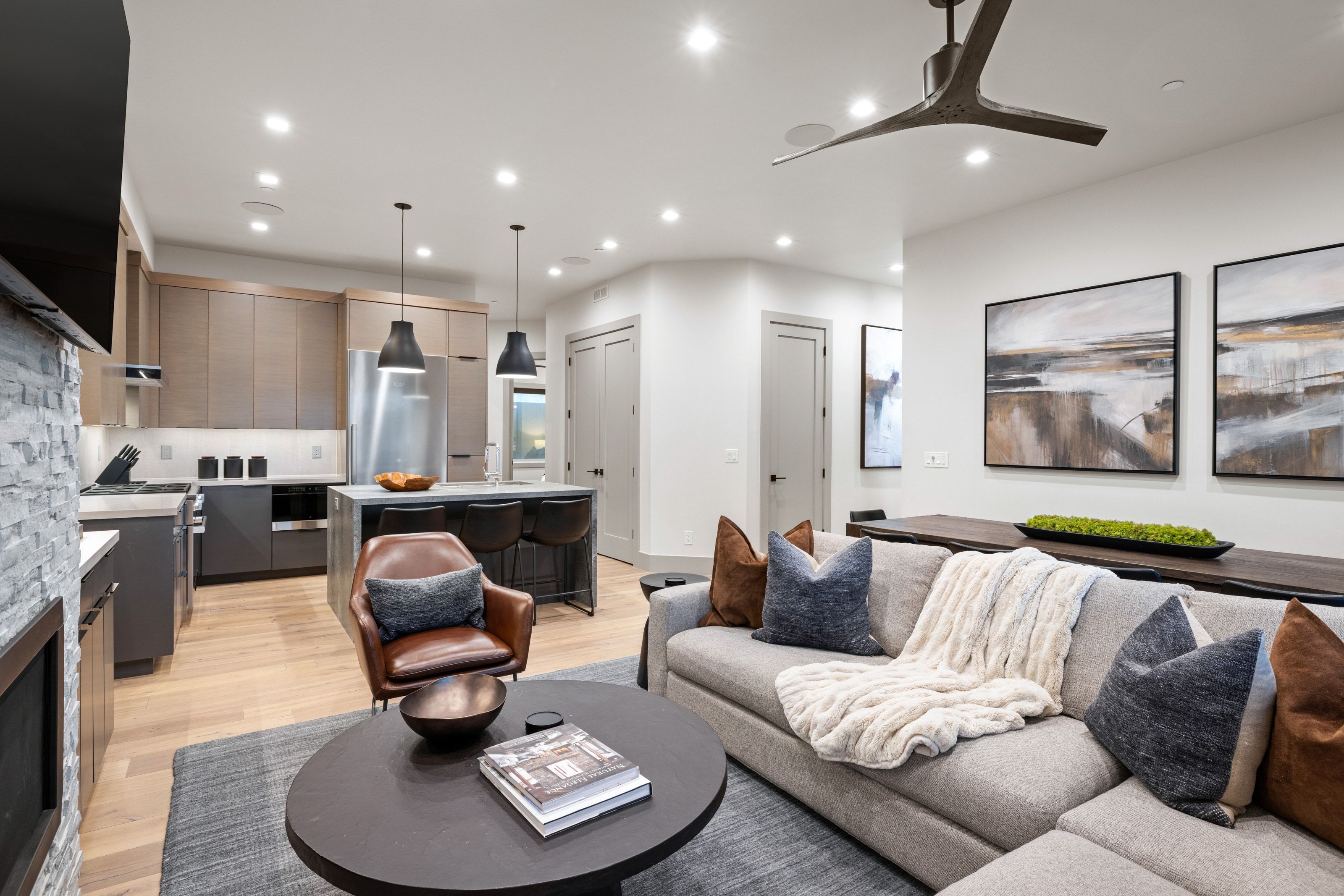 Open-concept living space featuring wood-finish flooring, recessed lighting, and a contemporary ceiling fan