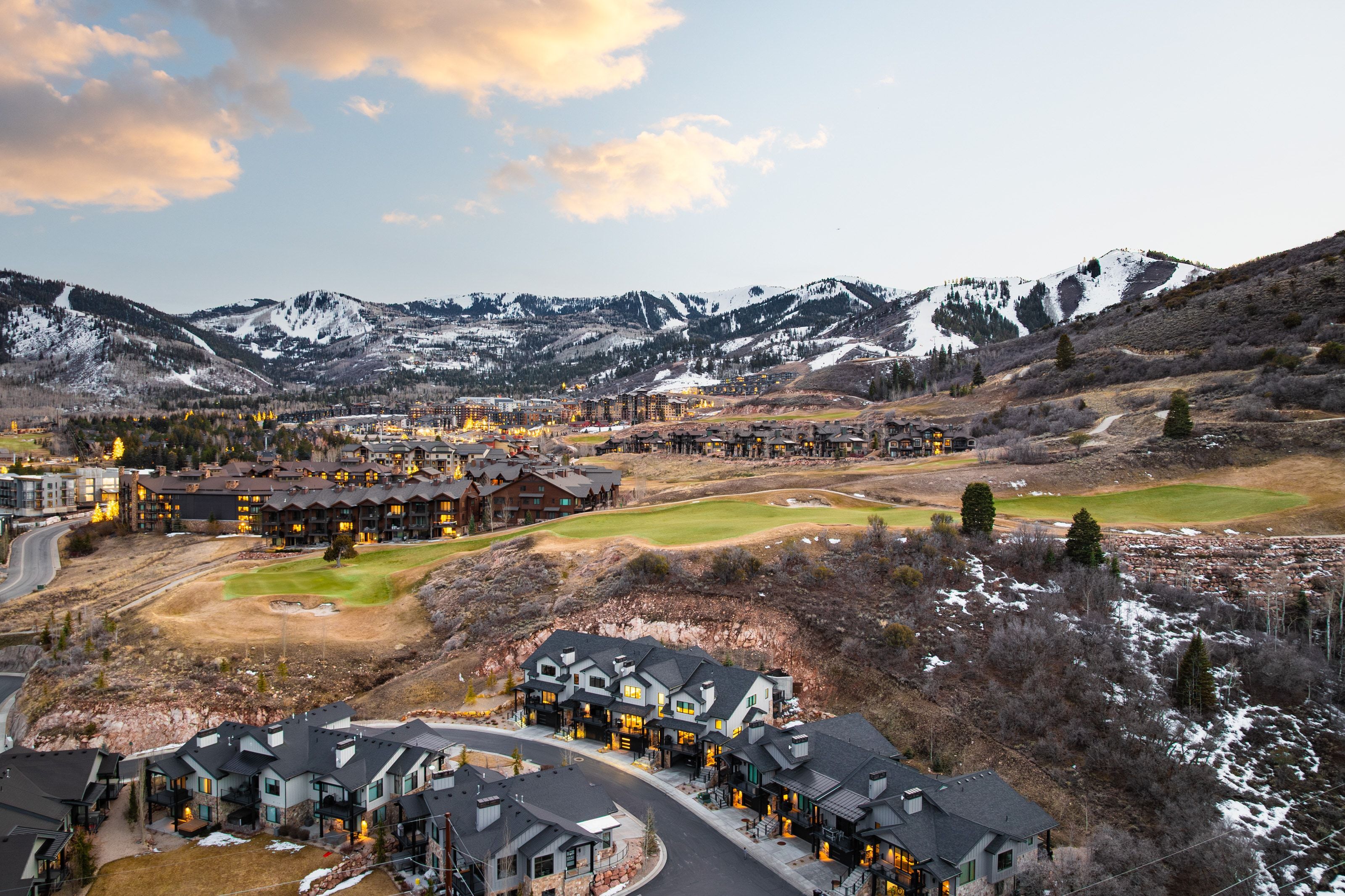 Residential properties nestled into a mountainous landscape with snow-capped peaks