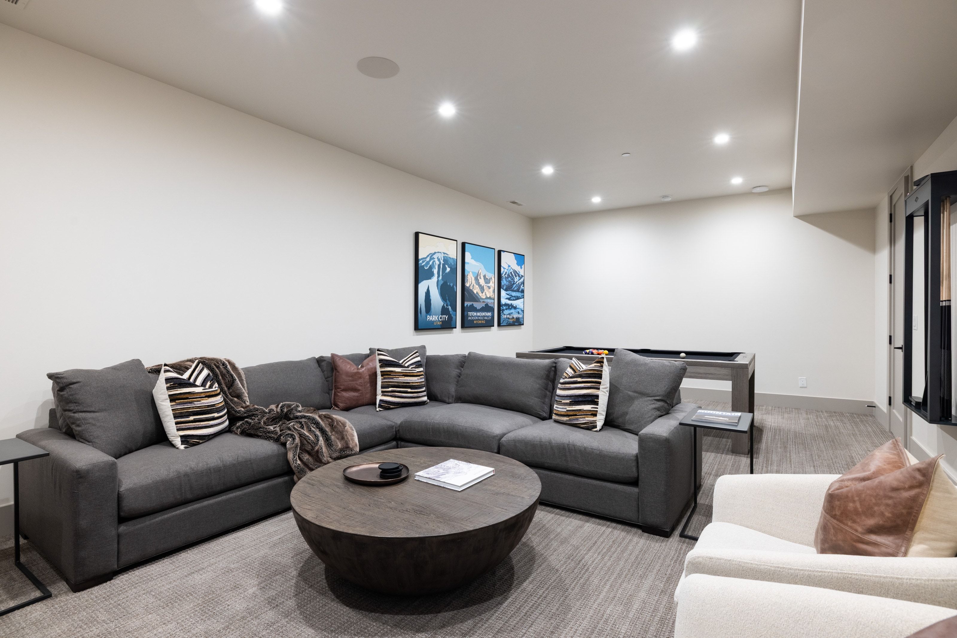 Spacious recreation room featuring recessed lighting, a built-in ceiling speaker, and light-toned walls