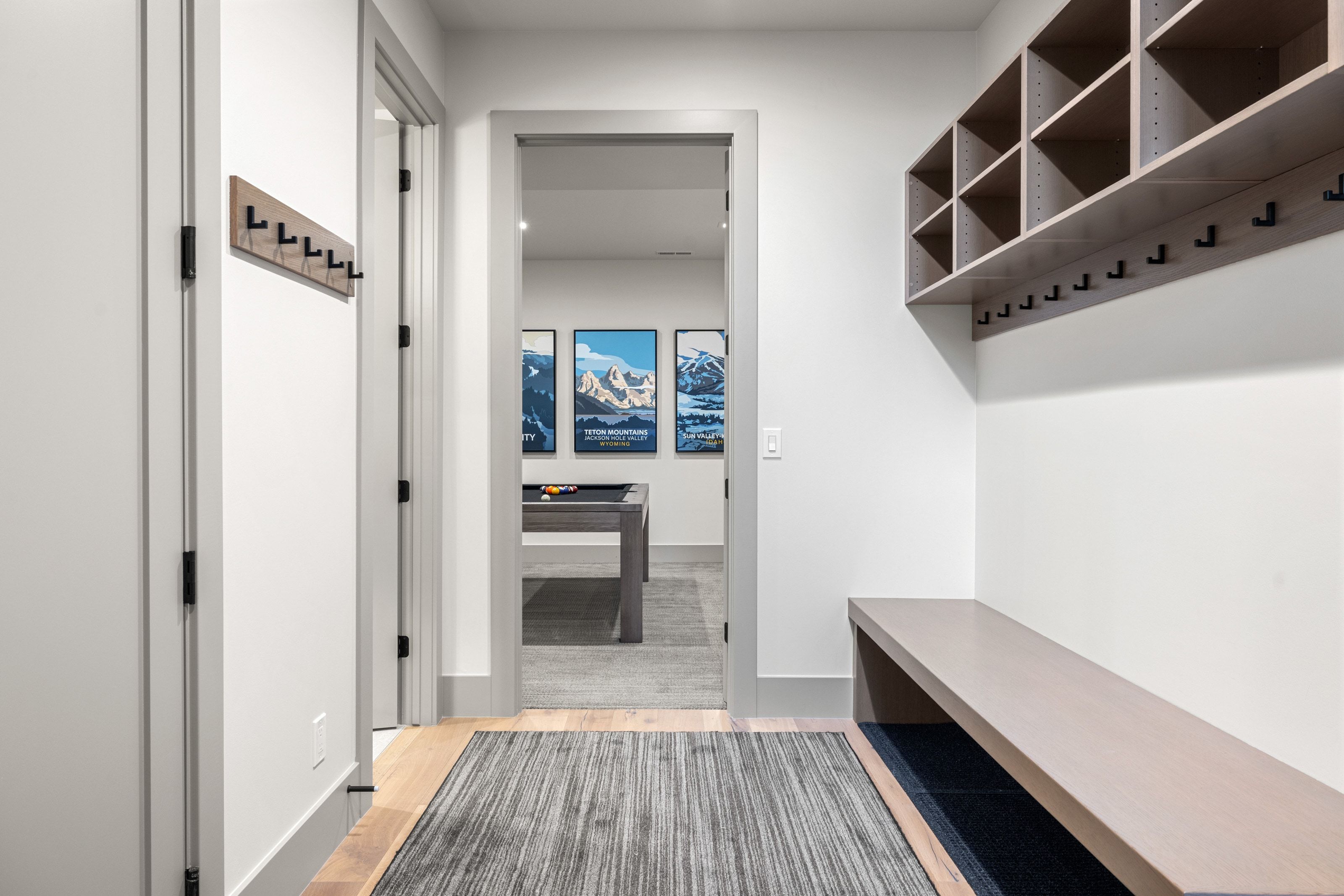 Entryway featuring a built-in bench, overhead cubbies, and multiple coat hooks