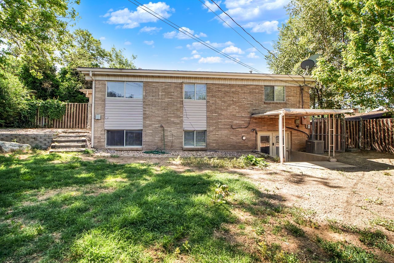 Brick exterior featuring multiple windows, a covered patio area and walk-out.