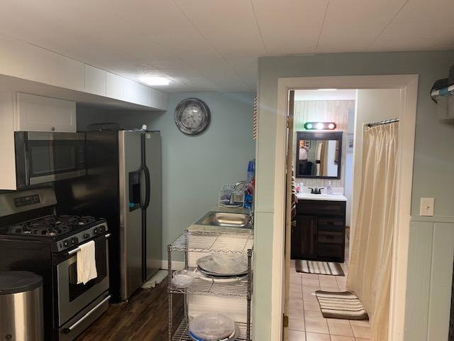 Kitchen area featuring stainless steel appliances and overhead cabinetry