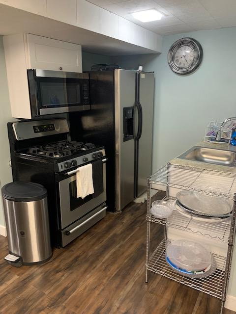 Compact kitchen space featuring wood-finish flooring
