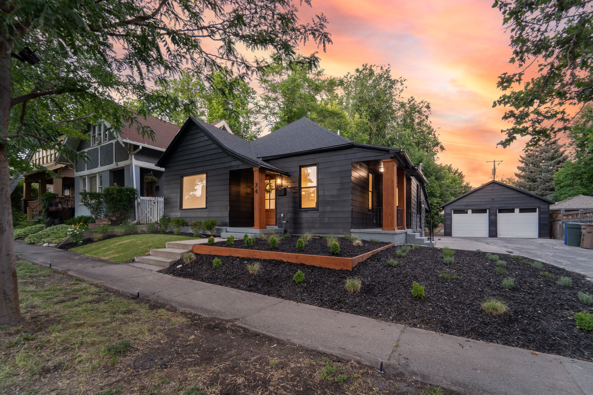 Modern black exterior with natural wood-tone accents