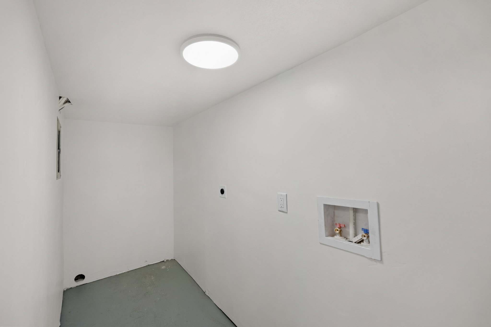 Utility room with white walls, a flush-mount ceiling light, and a dedicated laundry hookup box