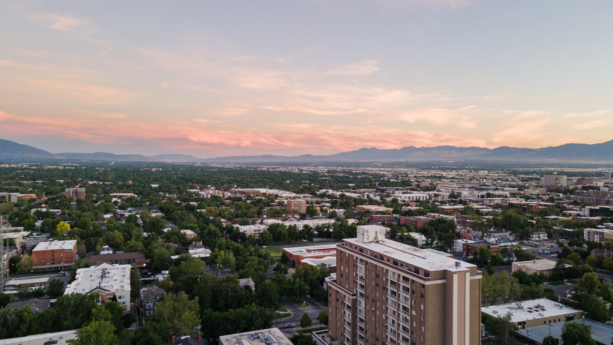Expansive aerial perspective showcasing a city landscape with distant mountains