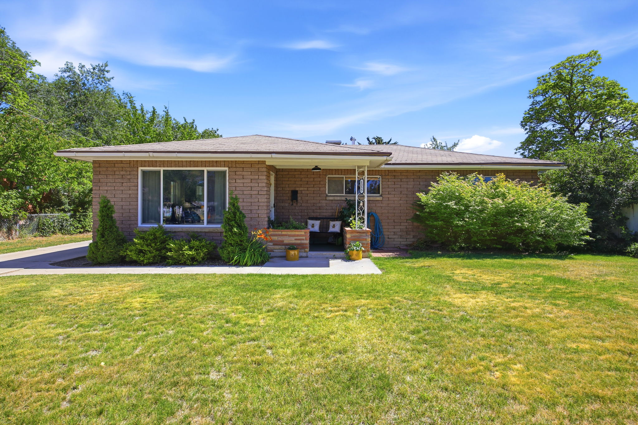 Brick exterior single-story residence with a covered entryway