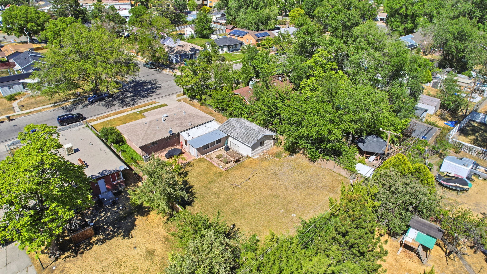 Aerial perspective showcasing a property with a brick exterior and a gabled roofline