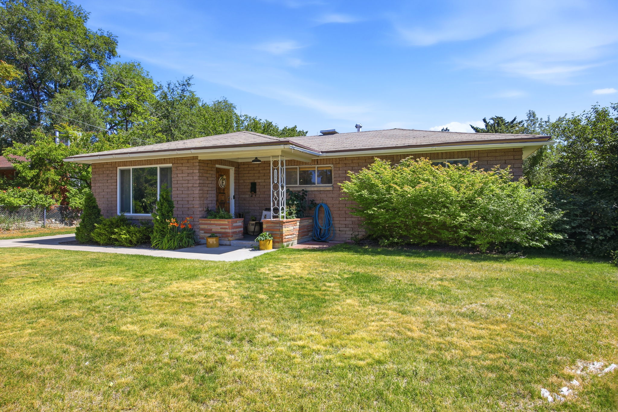 Single-story brick exterior with a low-pitch roof and prominent front porch