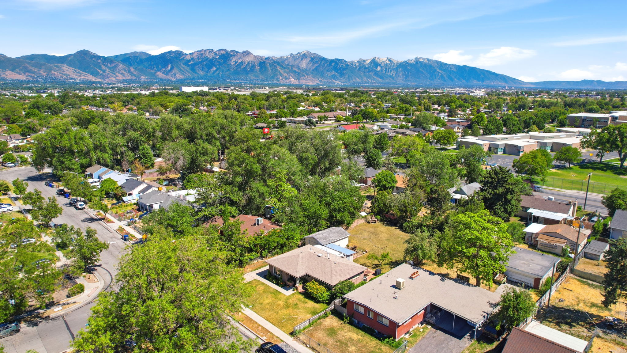 Expansive overhead view showcasing a residential neighborhood with a backdrop of distant mountains
