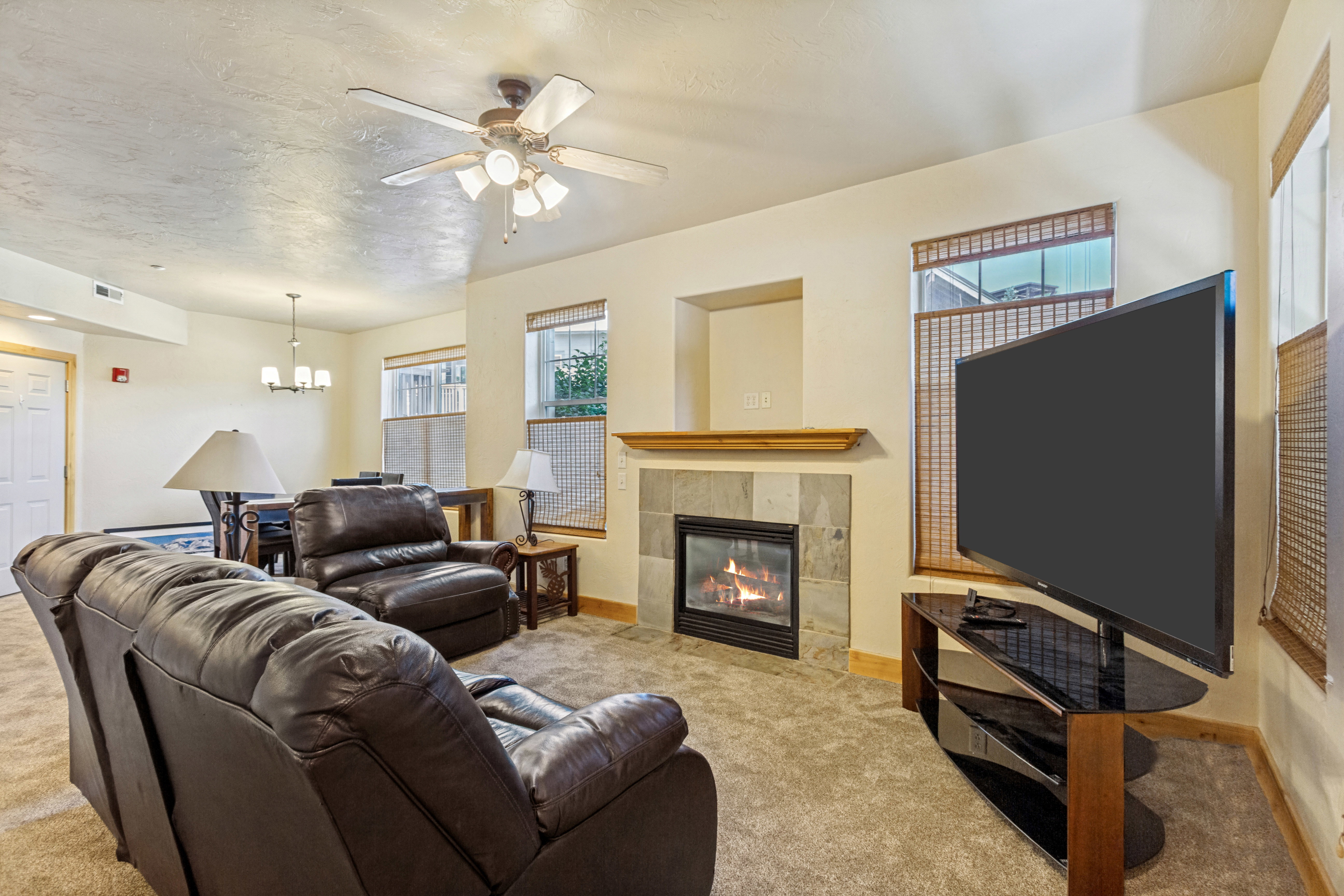 Living area with a built-in fireplace featuring a stone surround and wood mantel