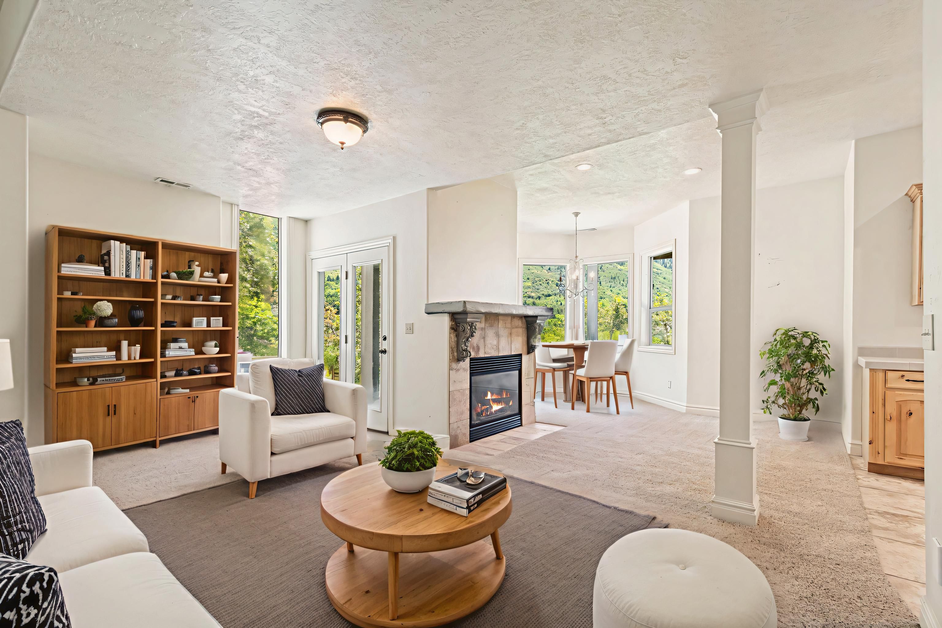 Living area featuring a stone-clad fireplace with a hearth, built-in shelving, and direct exterior access
