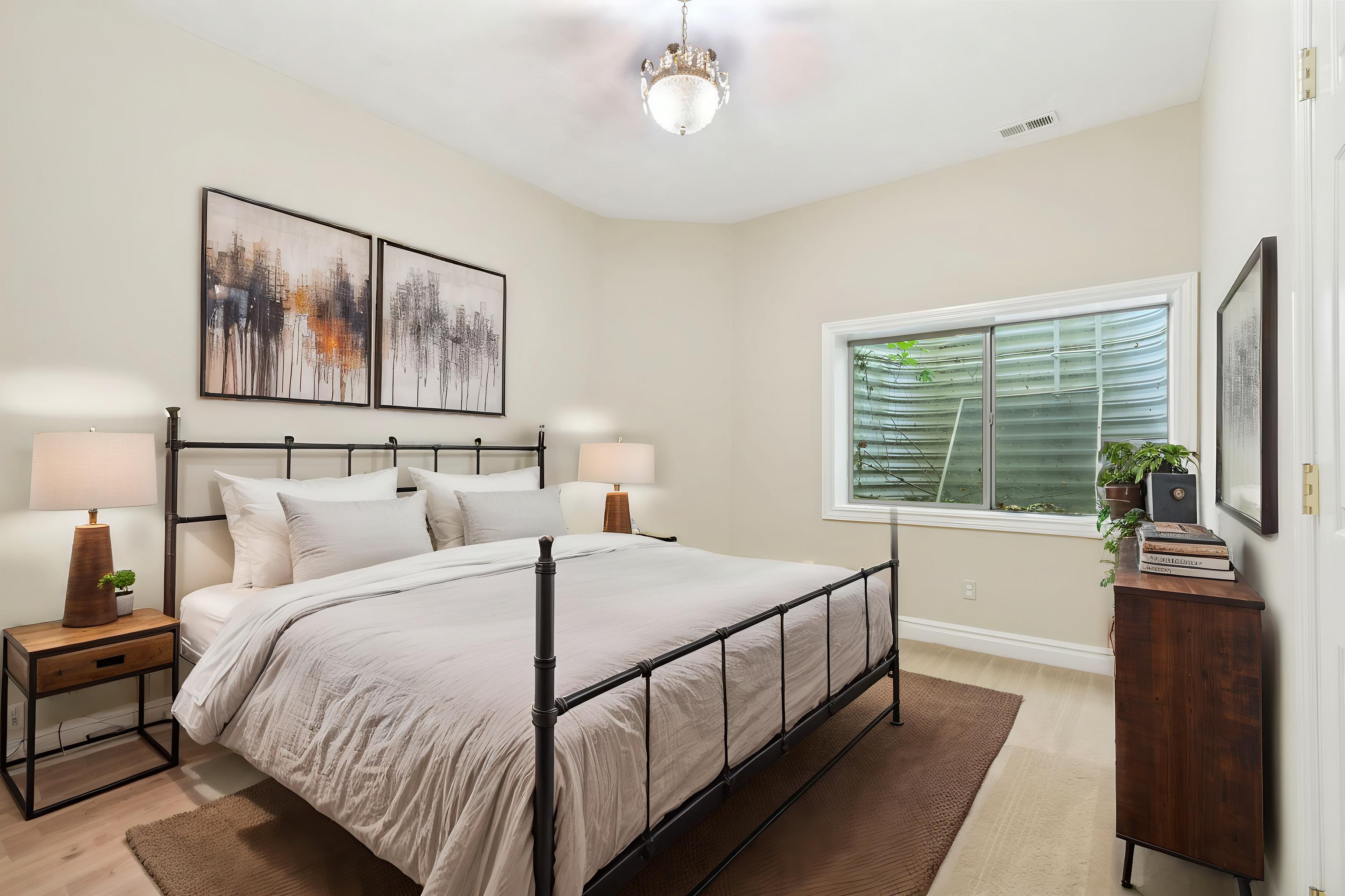 Bedroom featuring light wood-finish flooring and neutral wall tones