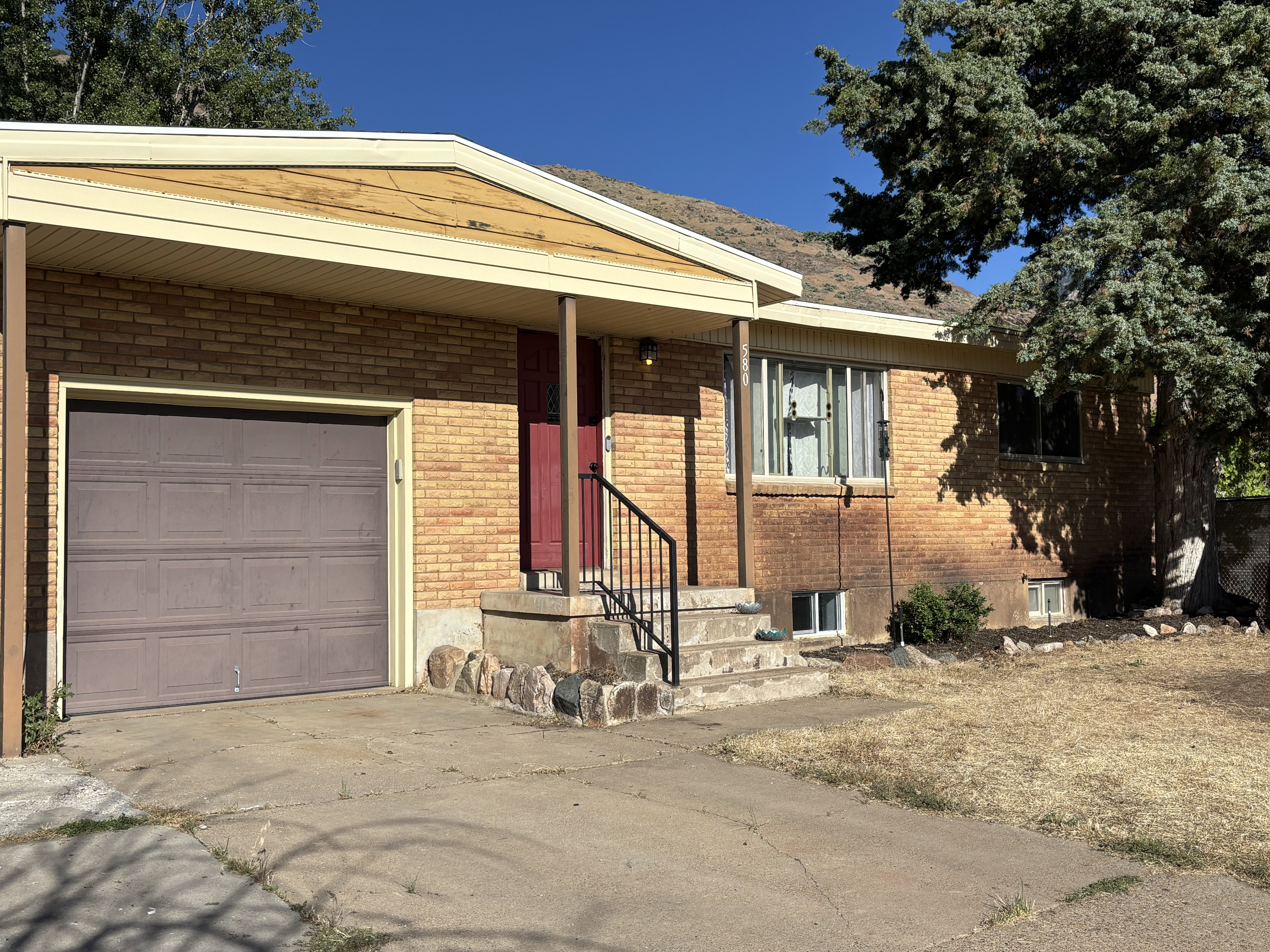 Brick exterior with an integrated garage and covered entry