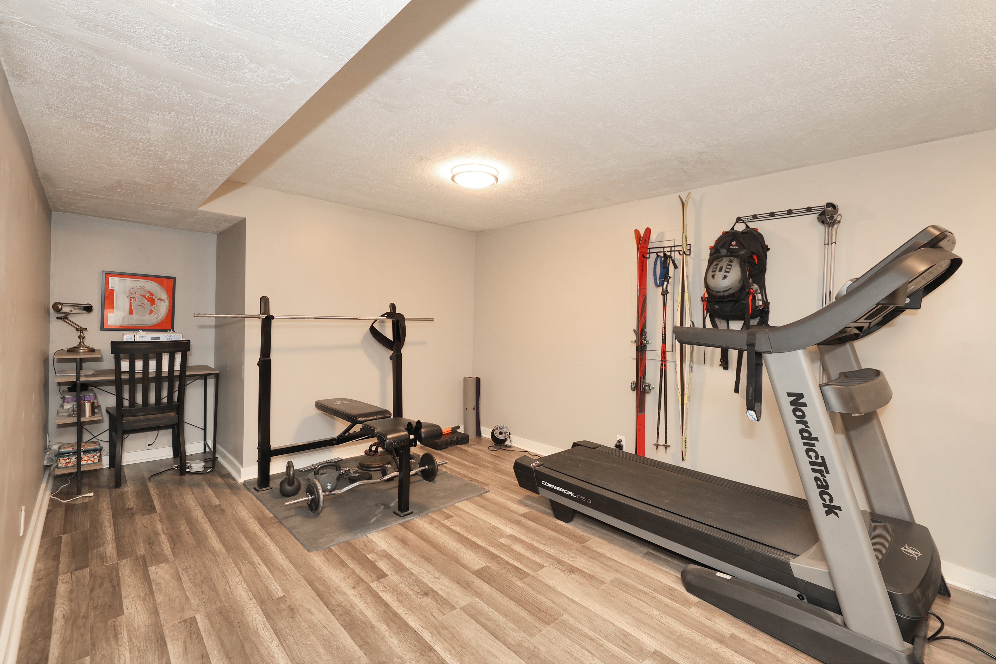 Versatile room featuring wood-finish flooring, neutral wall paint, and recessed lighting