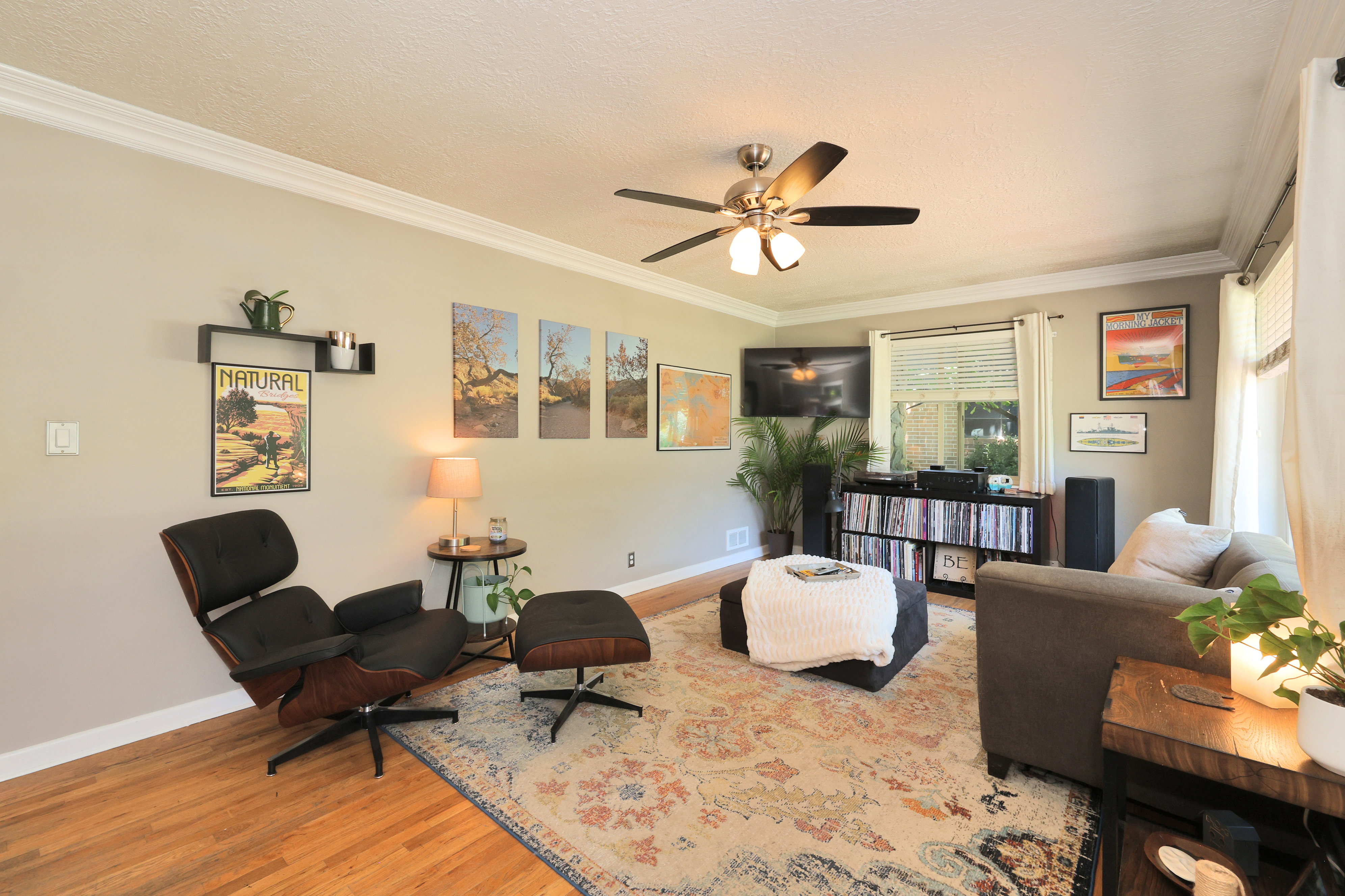 Living area featuring wood-finish flooring and crown molding