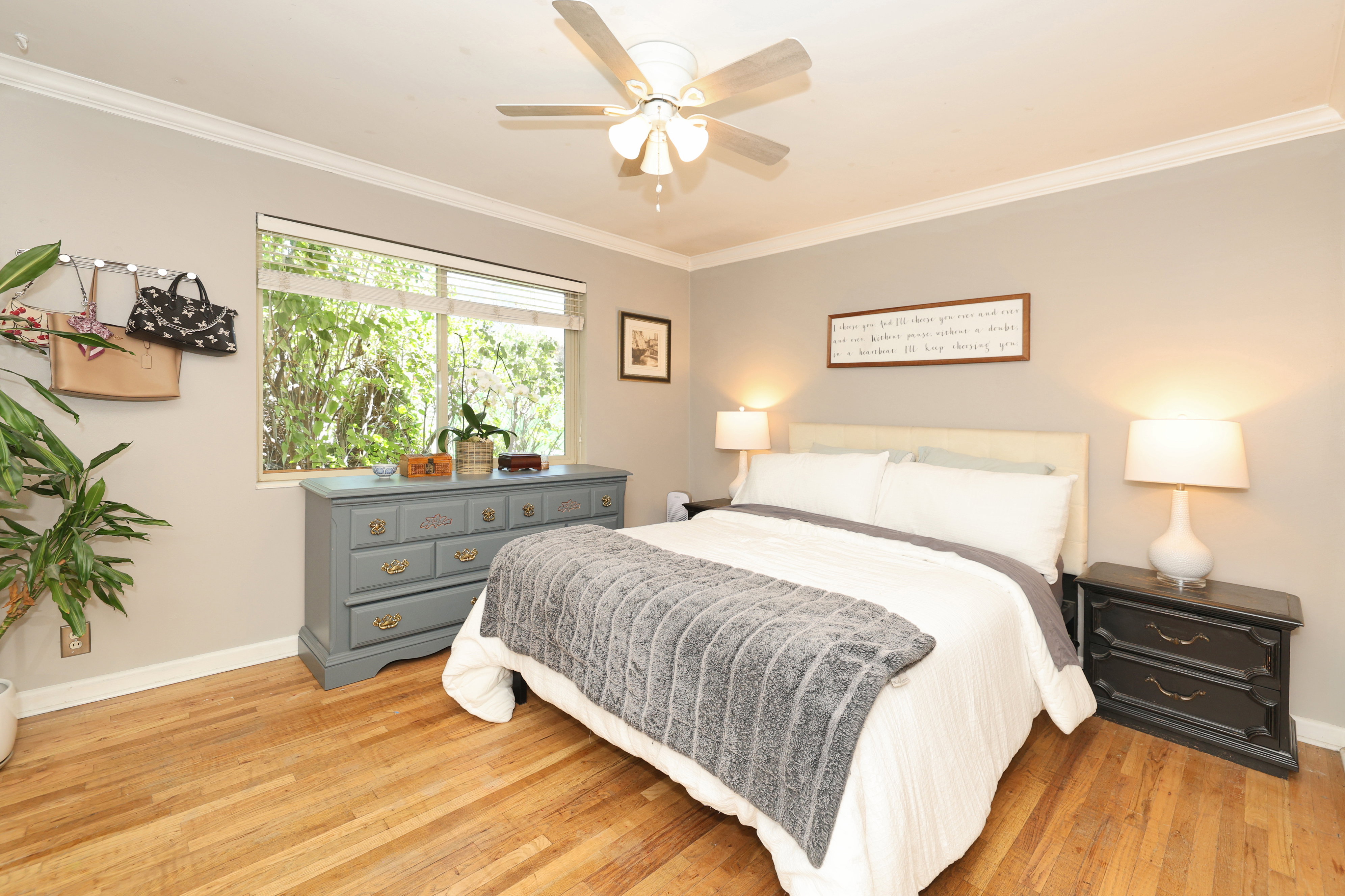 Bedroom featuring wood-finish flooring, a ceiling fan, and crown molding