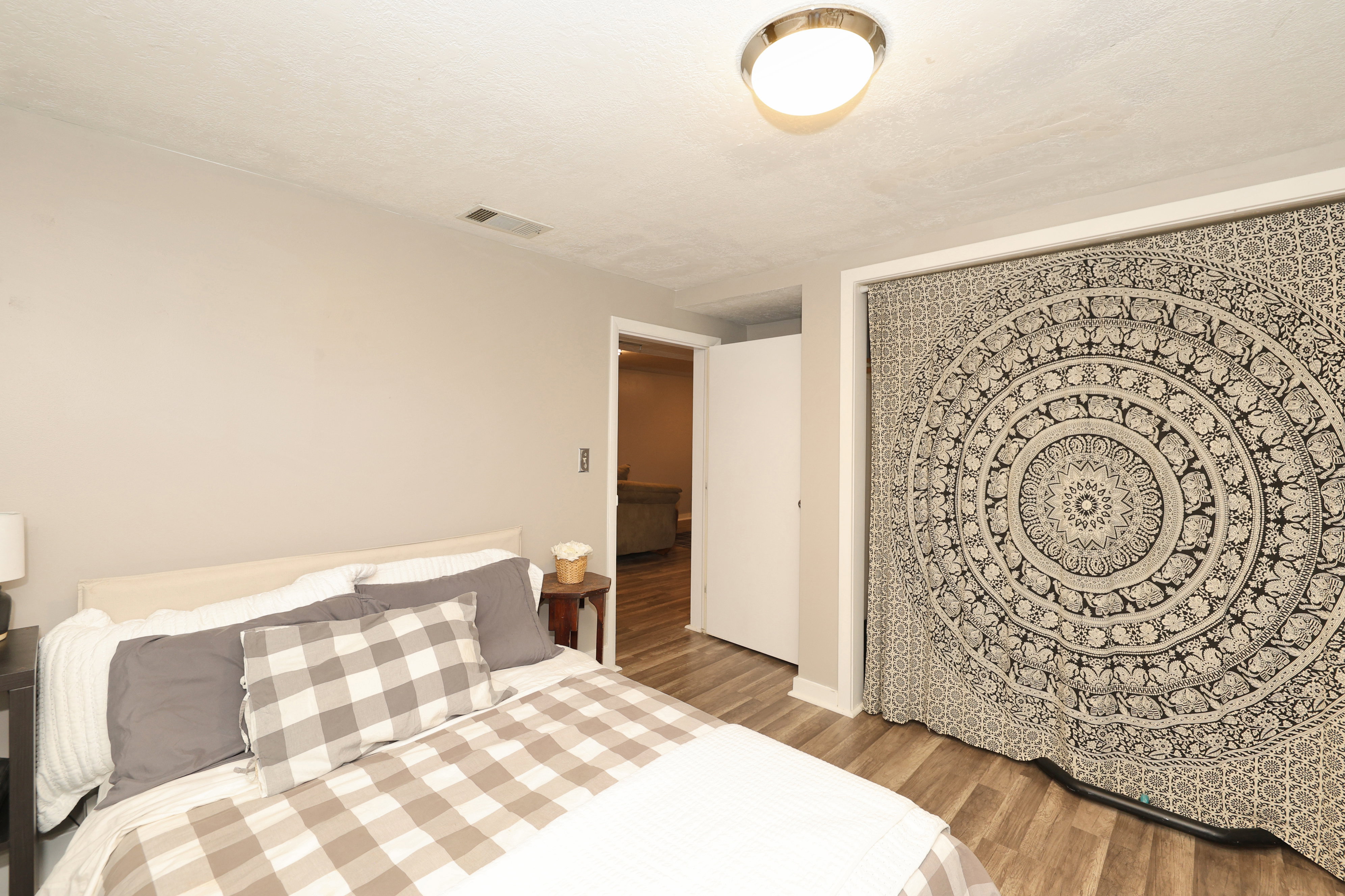 Bedroom featuring wood-finish flooring, neutral wall paint, and a semi-flush mount ceiling light