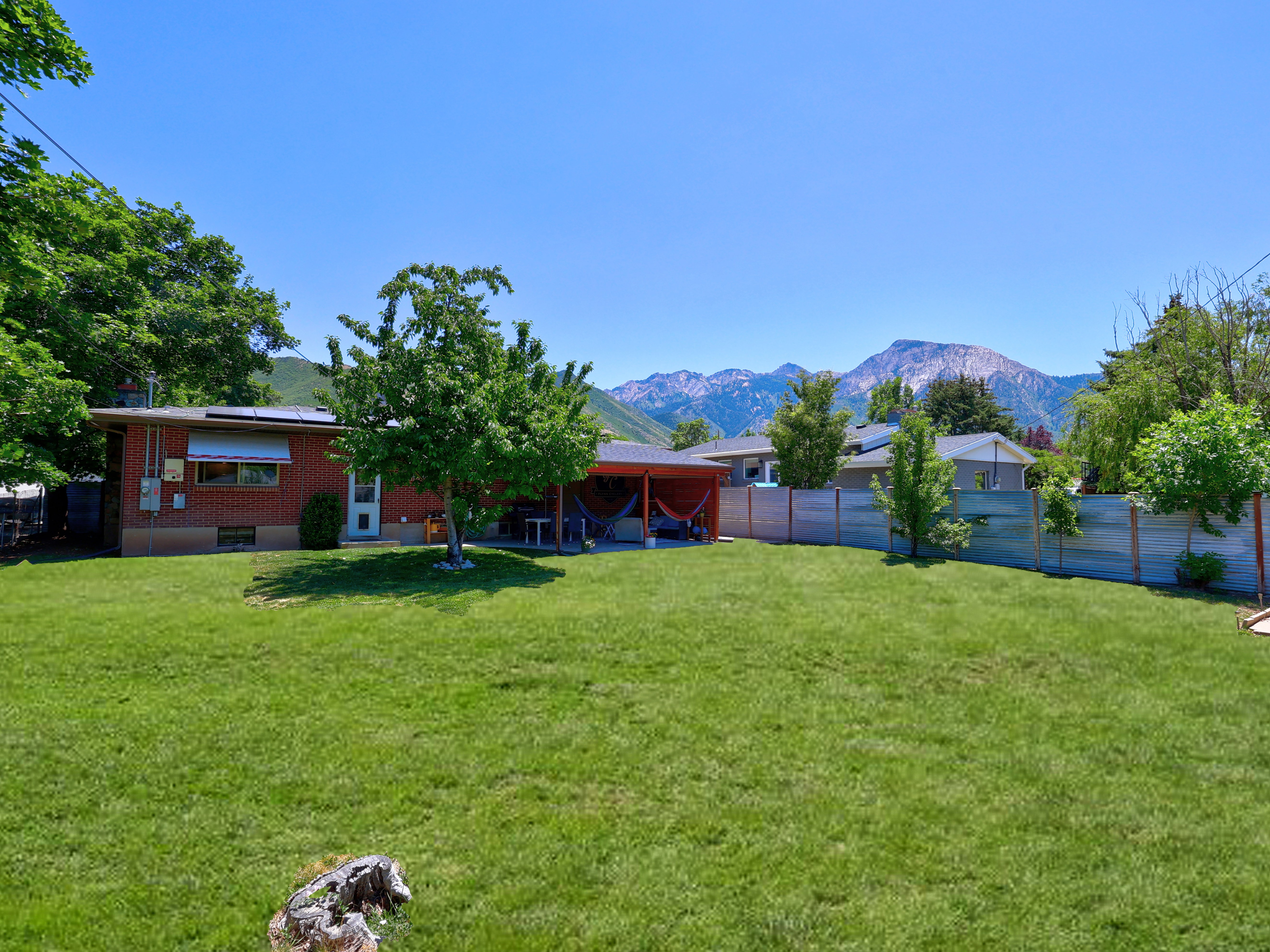 Expansive green lawn with mountain backdrop
