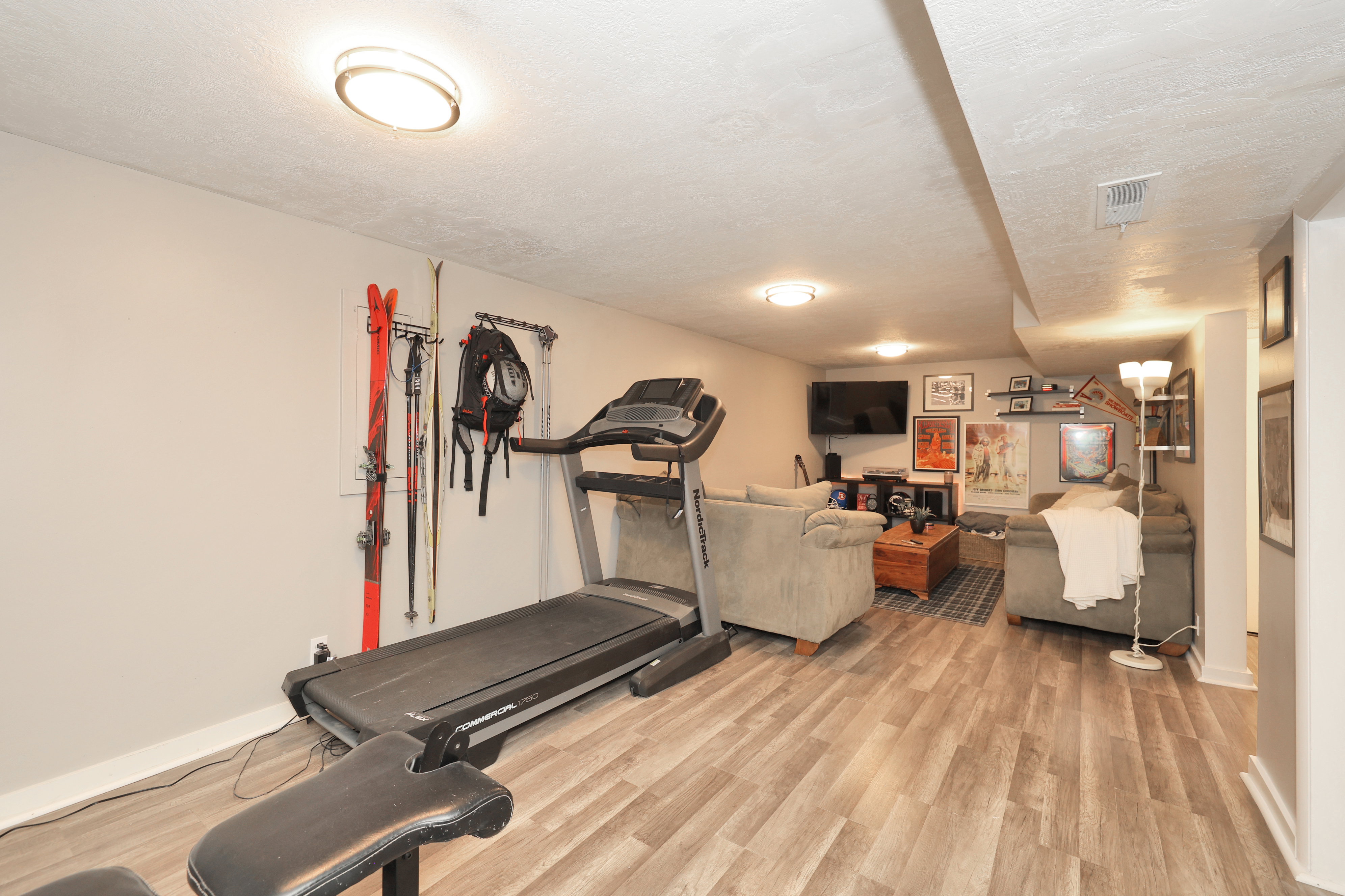 Recreation room featuring wood-finish flooring, recessed lighting, and a neutral color palette