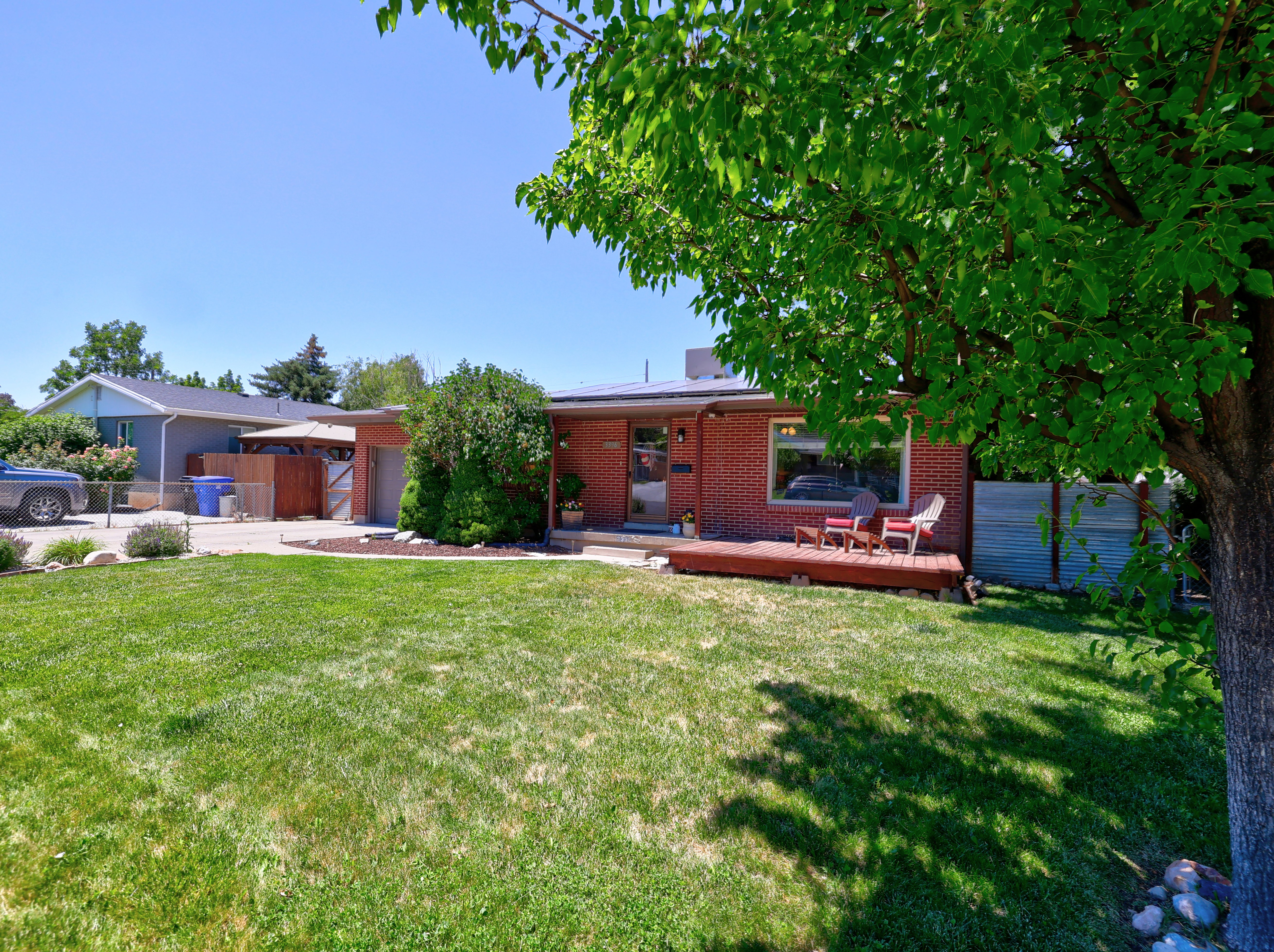 Red brick exterior with a front wood deck