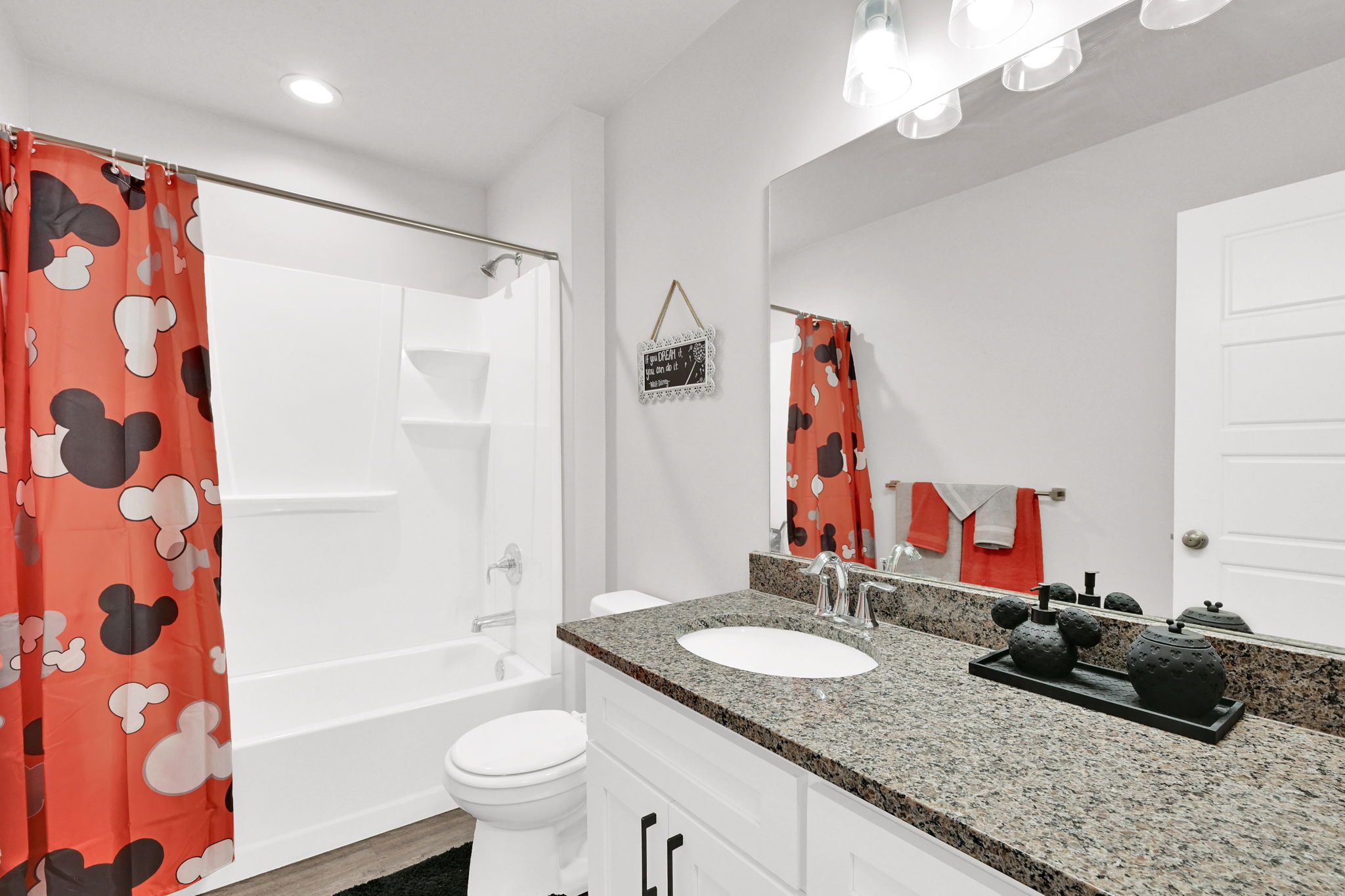 Bathroom featuring a full-size tub and shower combination with a white surround