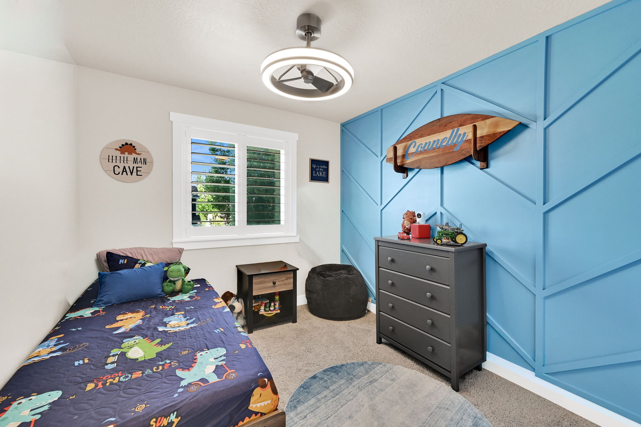 Room 2- featuring a  accent wall, window with plantation shutters, ceiling fan with integrated lighting, carpet and light-toned wall paint