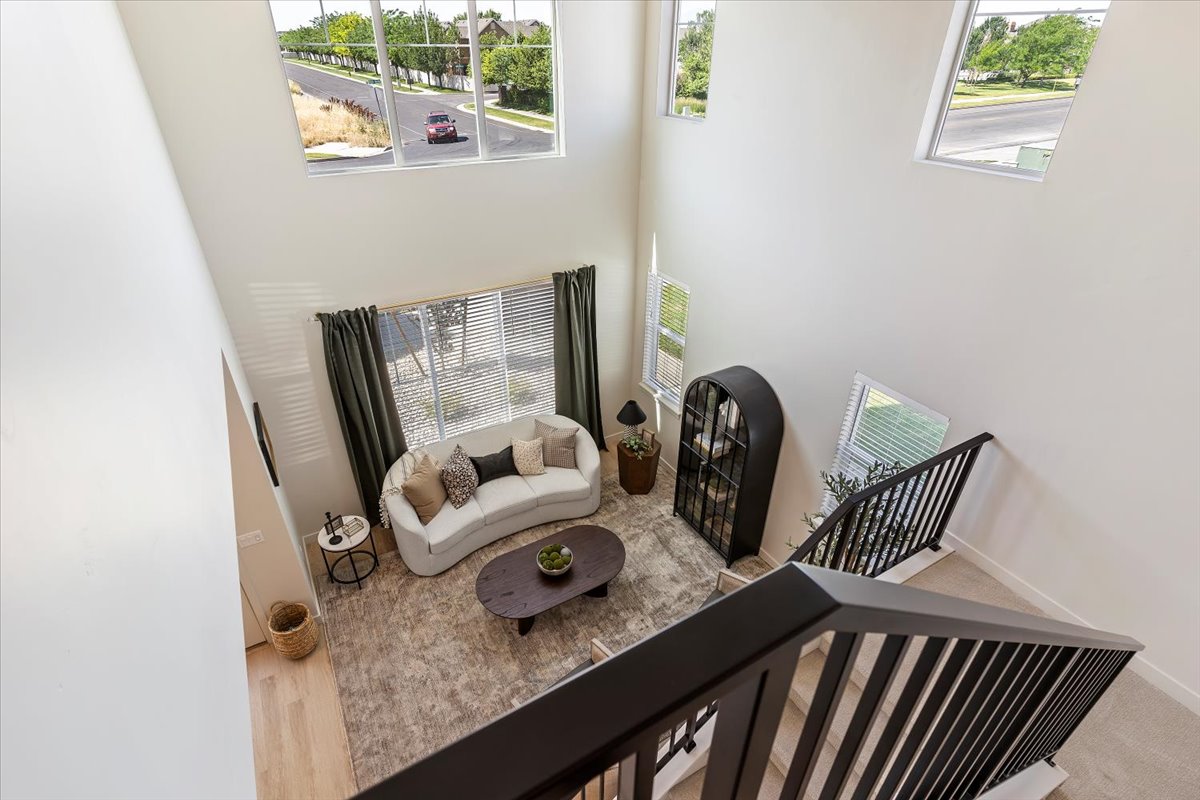Two-story living area with high ceilings and multiple windows