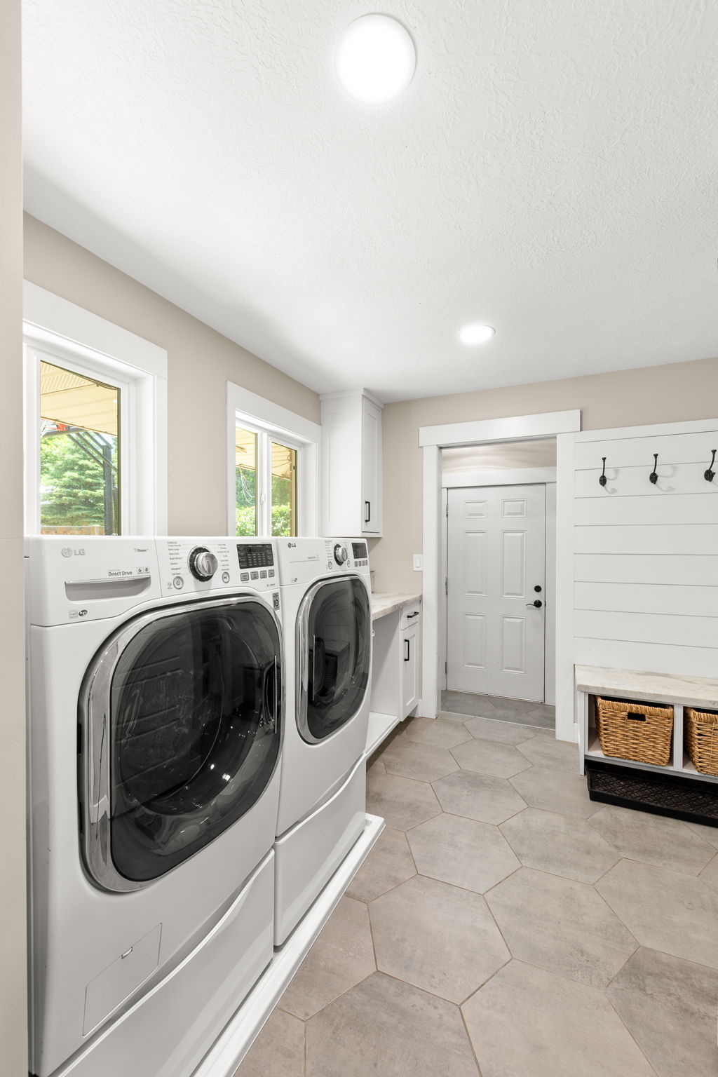Large Light Laundry Area!  Lots of Natural Light!  Windows span across front and back of house!