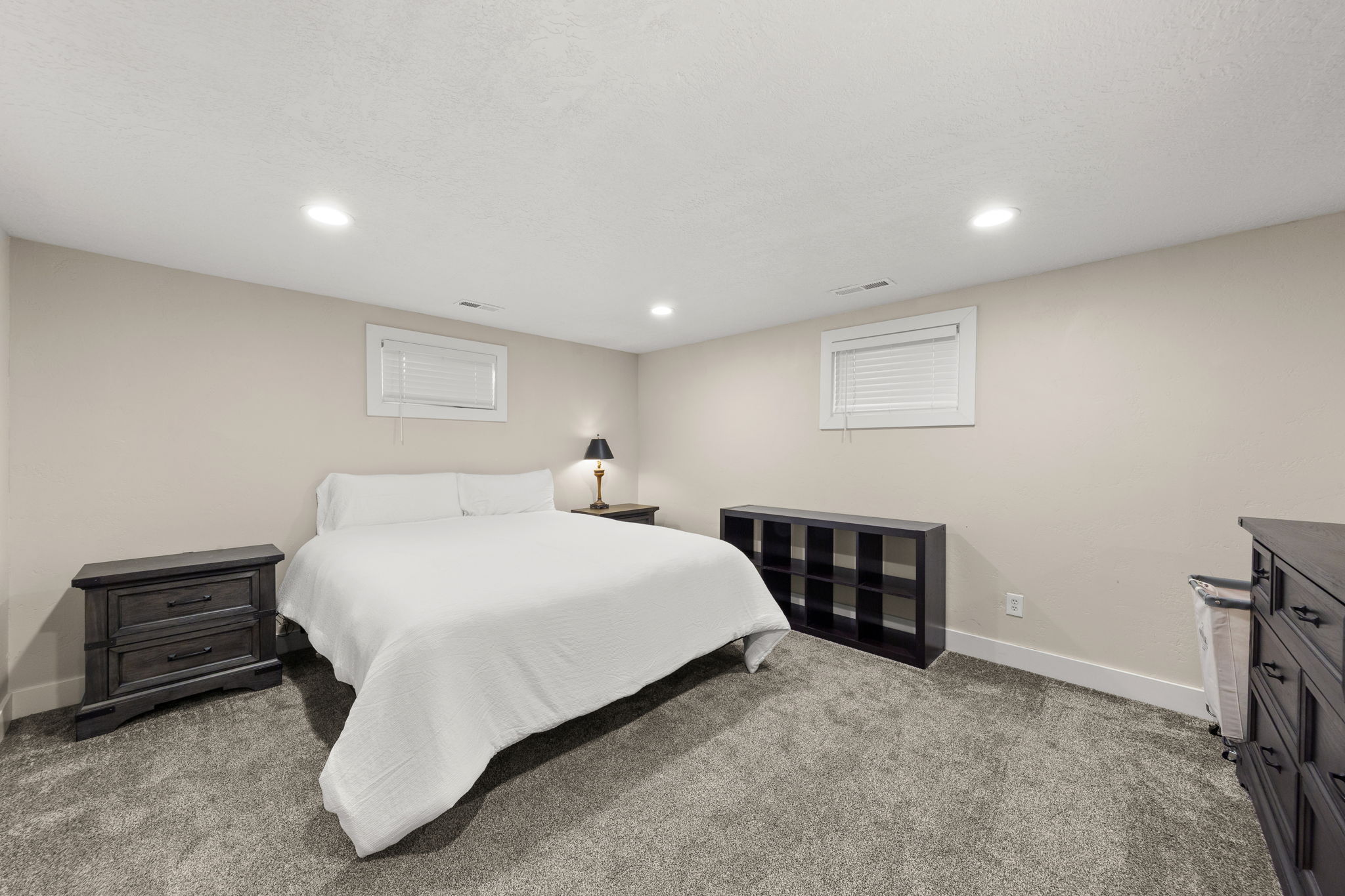 Remodeled Large Bedroom in Mother in Law Apartment showing a California King Bed.  With Blinds & Lots of Canned Lighting!